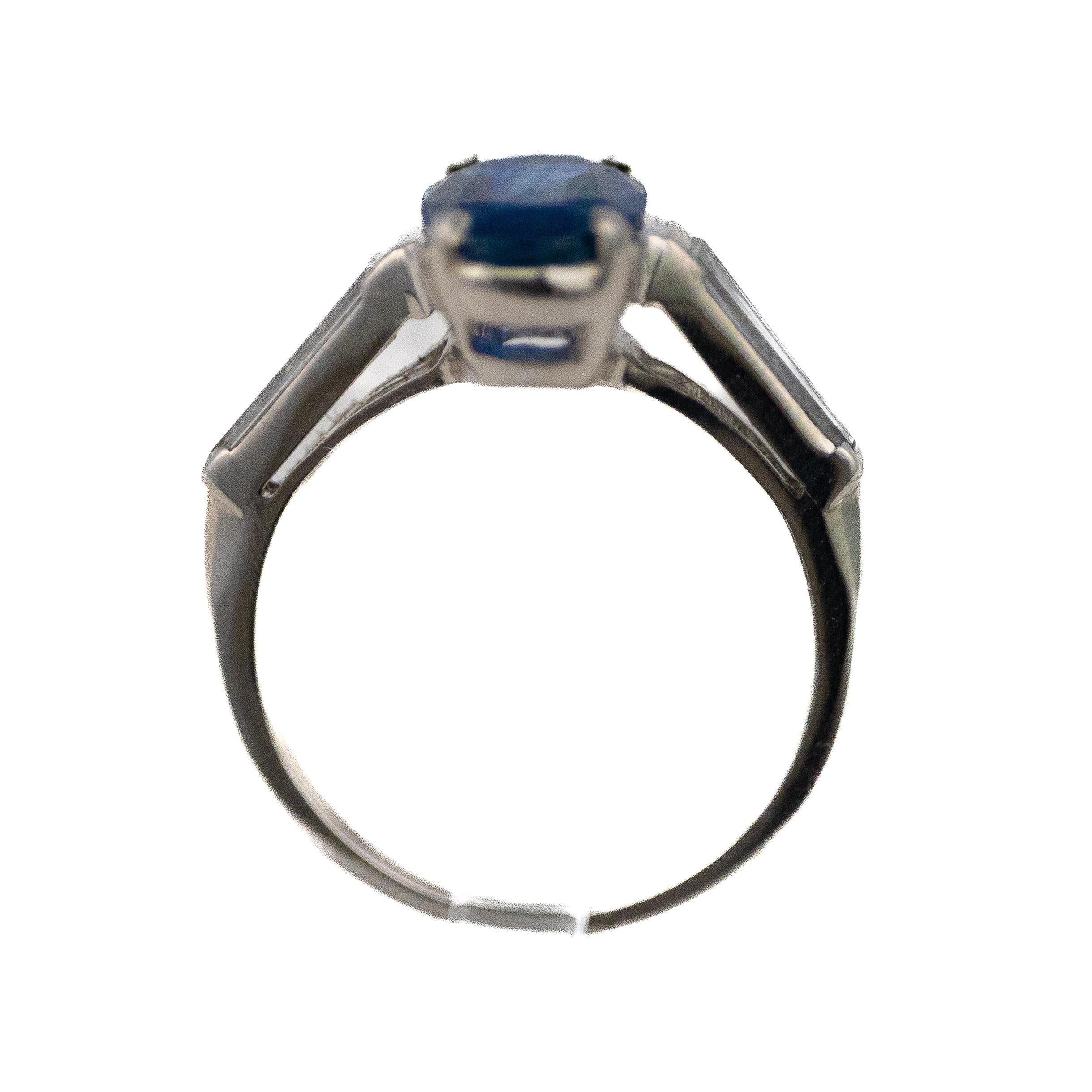 Oval geschliffener Saphir & spitz zulaufender Baguette-Diamantenring 

Beschreibung: Ein raffinierter Ring aus 14 Karat Weißgold mit einem blauen Saphir im Ovalschliff in der Mitte, flankiert von spitz zulaufenden Diamanten im Baguetteschliff auf