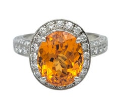 Oval Cut Spessartite Garnet and Diamond Halo Cocktail Ring in Platinum