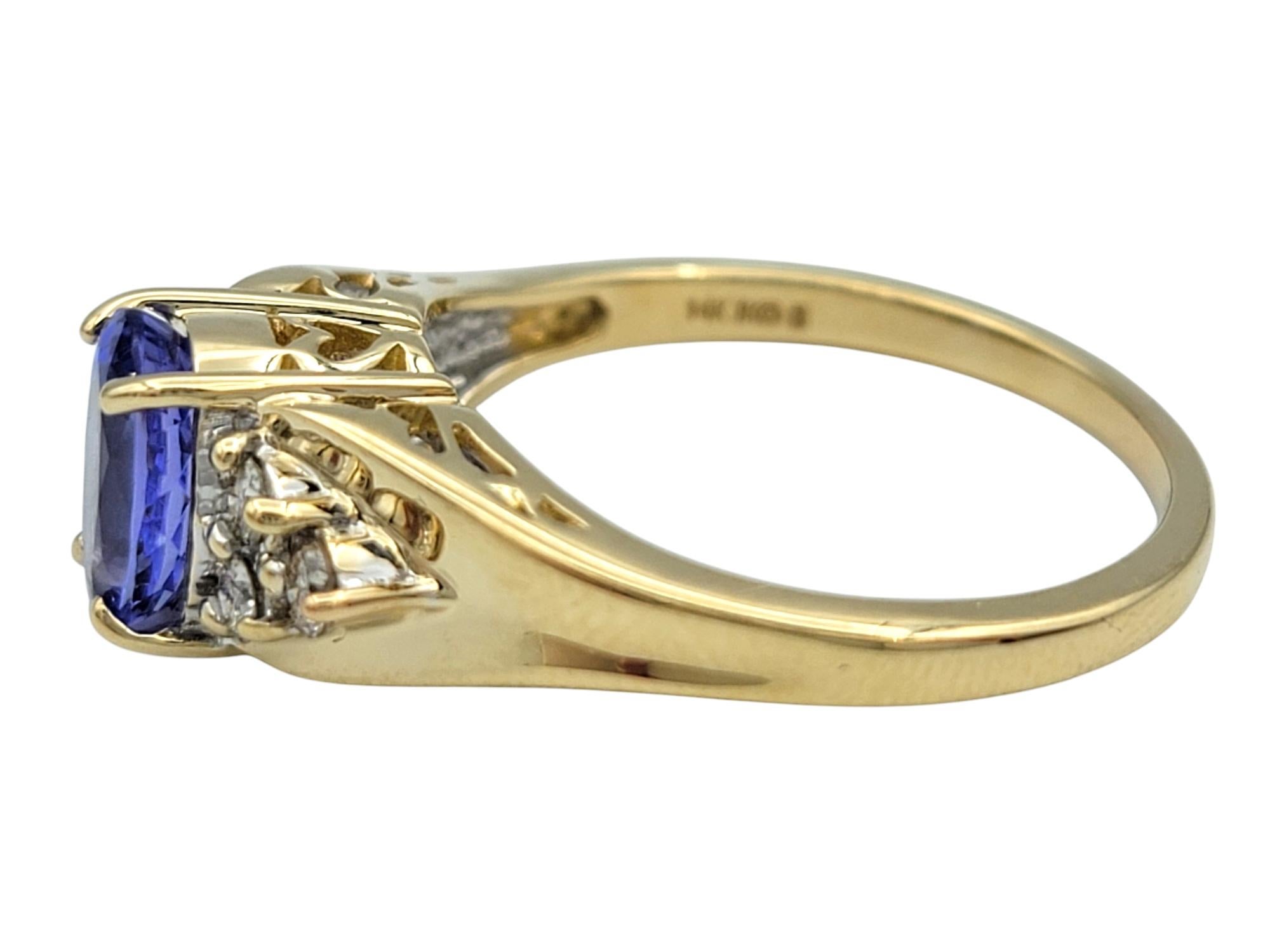 Oval Cut Tanzanite and Diamond Cluster Ring in Polished 14 Karat Yellow Gold In Good Condition For Sale In Scottsdale, AZ