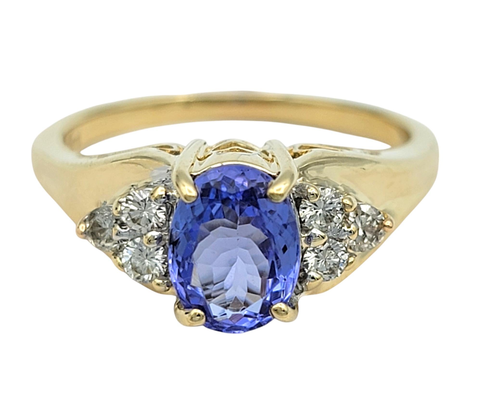 Women's Oval Cut Tanzanite and Diamond Cluster Ring in Polished 14 Karat Yellow Gold For Sale