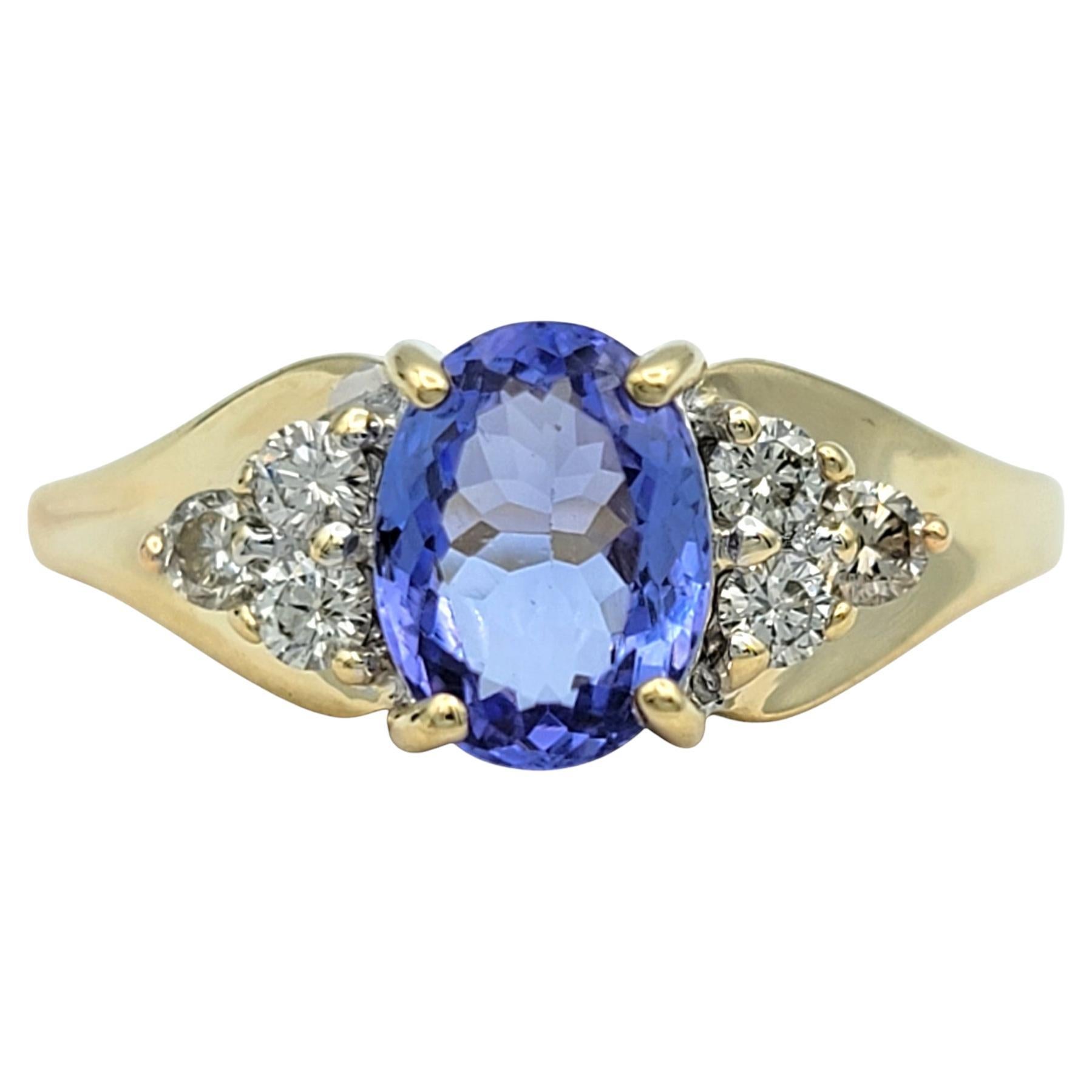 Oval Cut Tanzanite and Diamond Cluster Ring in Polished 14 Karat Yellow Gold