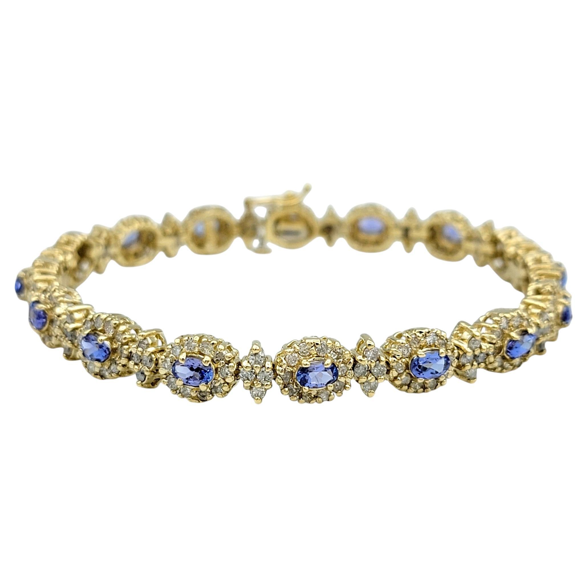 Oval Cut Tanzanite and Diamond Halo Line Bracelet in 14 Karat Yellow Gold