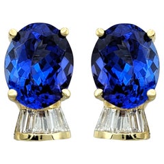 Oval Cut Tanzanite and Diamond Omega Back Stud Earrings in 14 Karat Yellow Gold