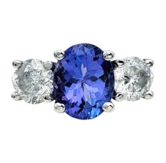 Oval Cut Tanzanite and Diamond Three Stone Band Ring in Polished Platinum