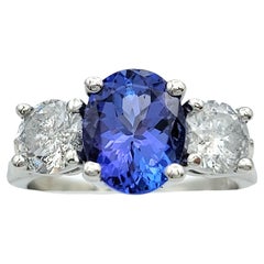 Oval Cut Tanzanite and Diamond Three Stone Band Ring in Polished Platinum
