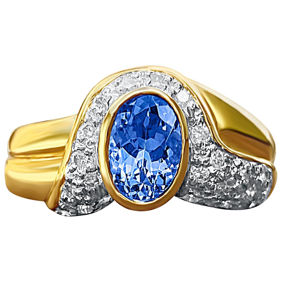 0.62 Carat Oval Cut Tanzanite, Diamond and 14K Yellow Gold Ring For Sale
