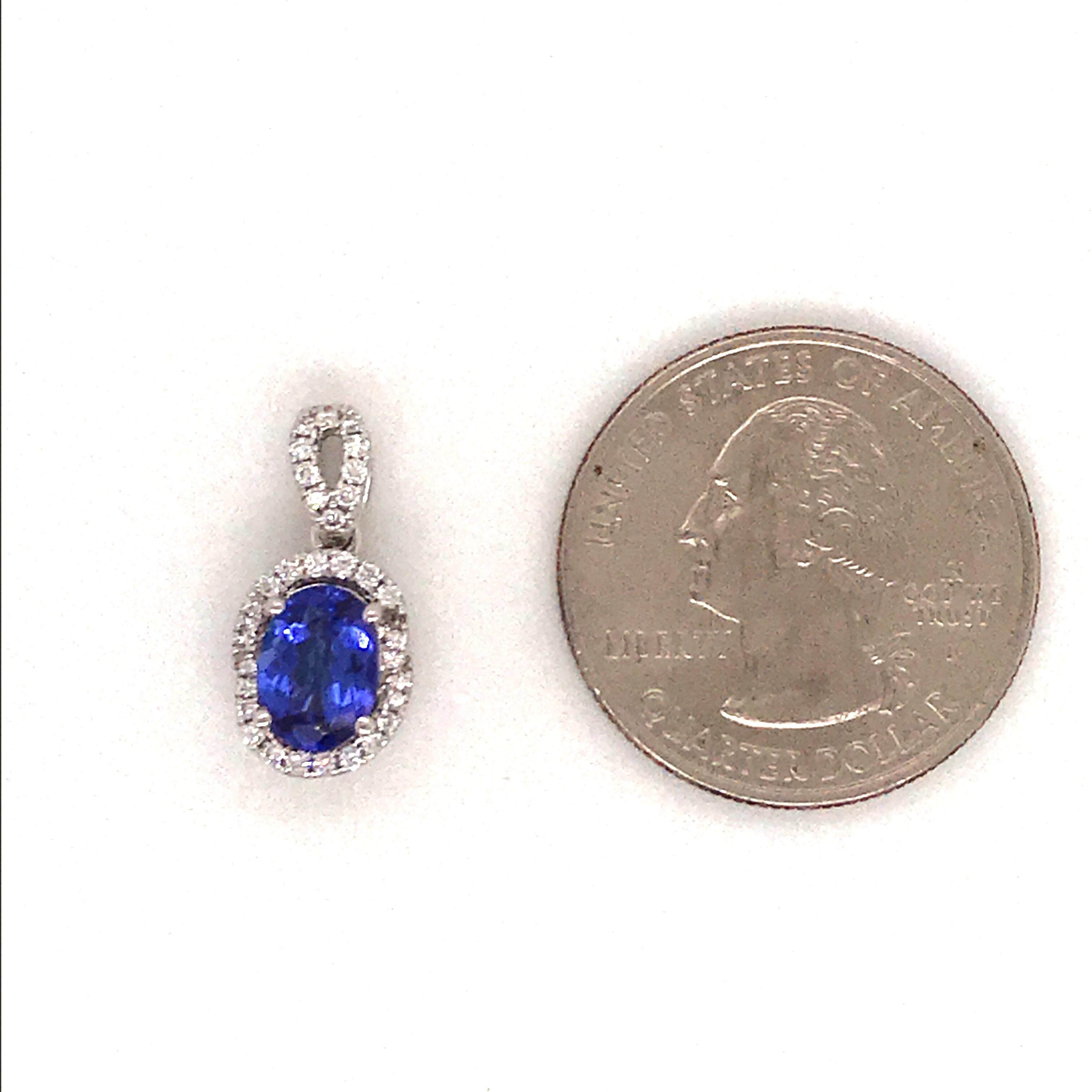 14K White gold pendant featuring one oval cut tanzanite weighing 1.33 carats flanked with round brilliance weighing 0.22 carats. Comes with 14k white gold chain. 
Color G
Clarity SI 