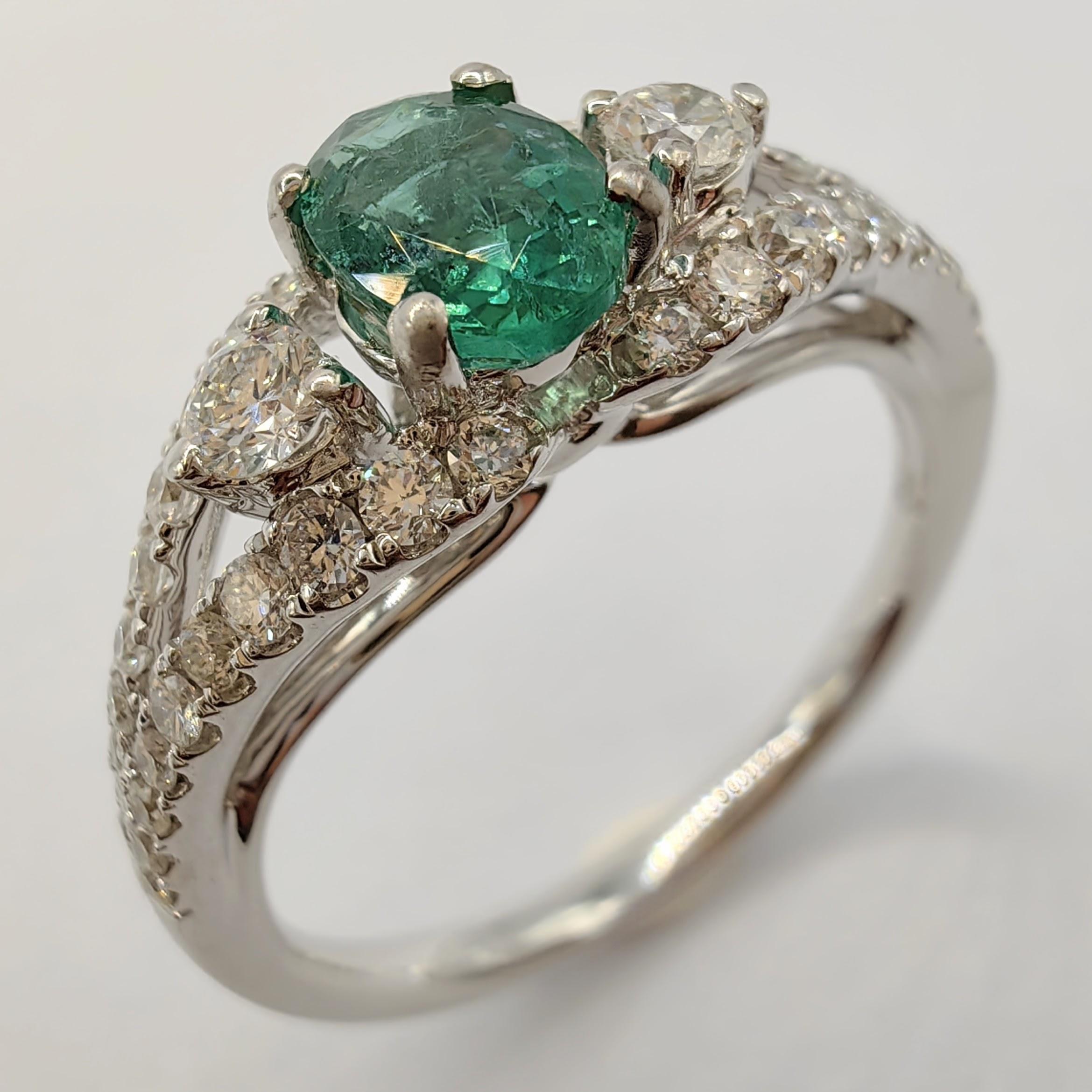 Introducing our stunning Oval-cut Emerald Diamond Cluster Ring, an exquisite dainty piece of jewelry that exudes elegance. The centerpiece of this ring is a beautiful 0.50ct oval-cut emerald. The center stone is surrounded by two 0.06 carat
