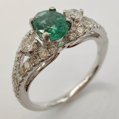 Oval-Cut Vivid Green Emerald Diamond Cluster Ring in 18k White Gold