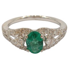 Oval-Cut Vivid Green Emerald Diamond Cluster Ring in 18k White Gold
