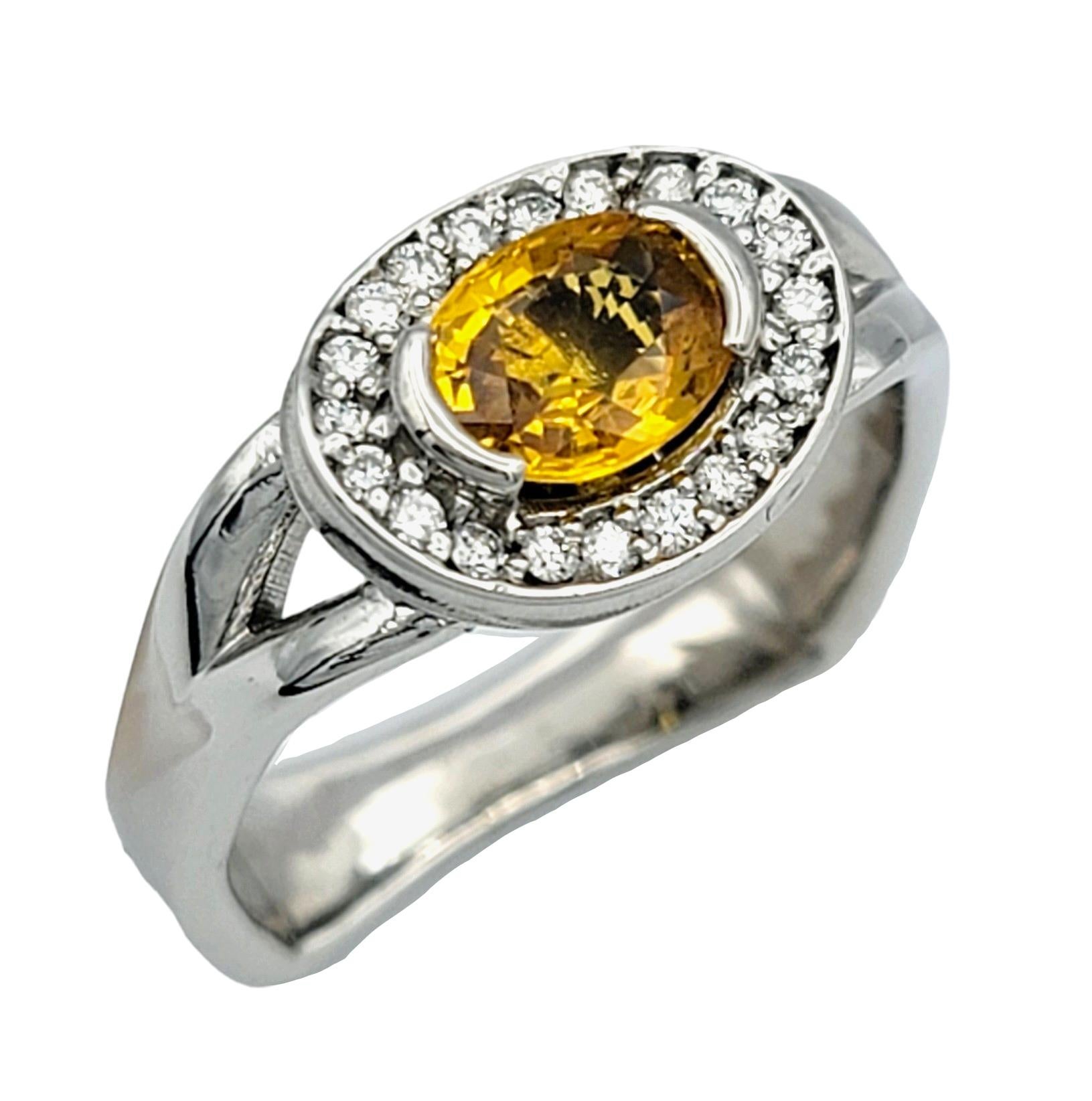 Ring size: 7.5

Indulge in timeless elegance with this contemporary squared white gold split shank band ring, meticulously crafted for those who appreciate refined luxury. At its heart, an exquisite oval yellow sapphire captures attention with its