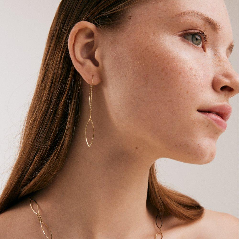Introducing the 14K Solid Gold Oval Dangle Threader Earrings, a testament to Orena Jewelry's dedication to merging traditional artistry with contemporary design. Each earring, meticulously crafted, embodies an elegance that effortlessly transitions