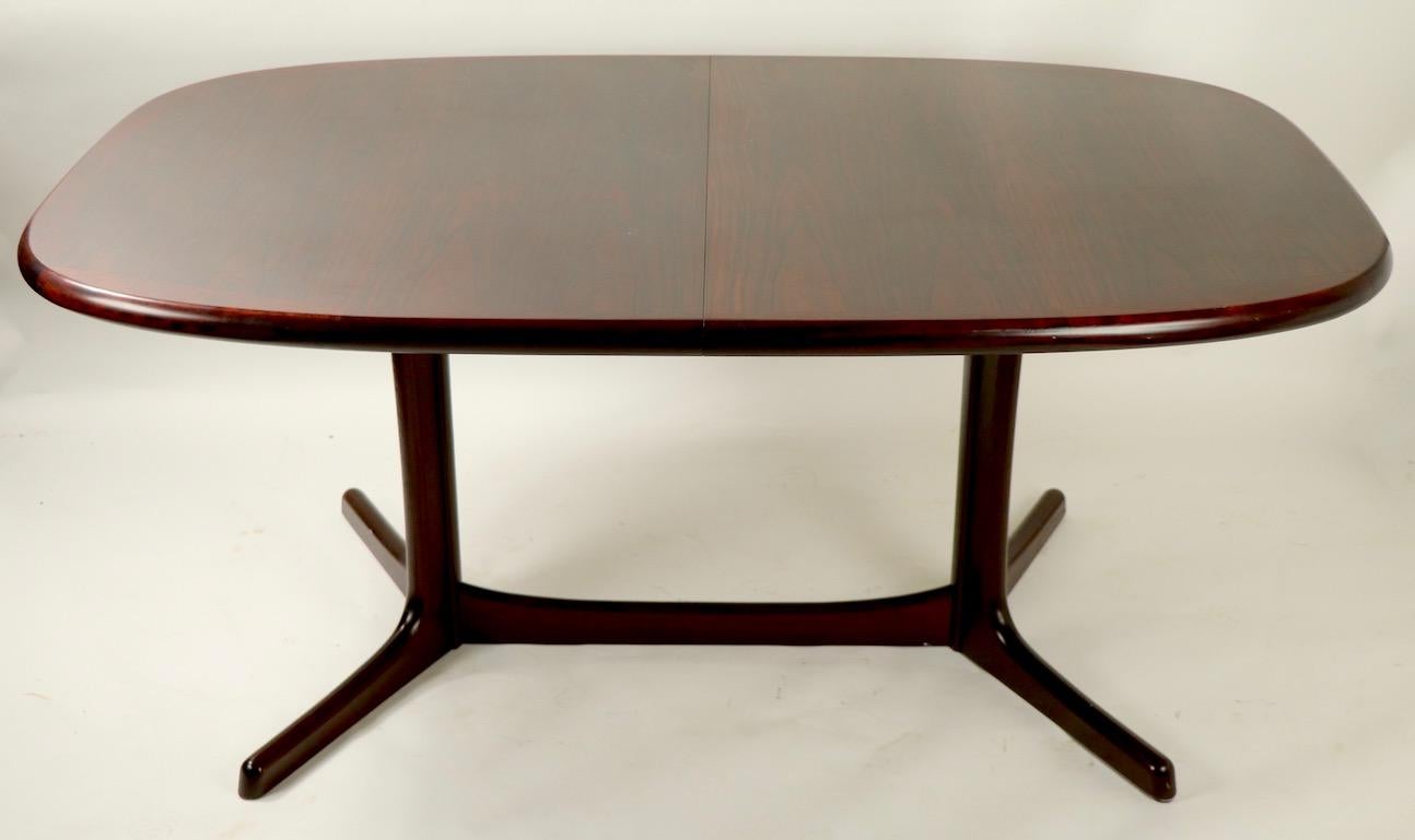 Slick and clean oval Danish modern dining table with sculpted base and 2 large leaves (20