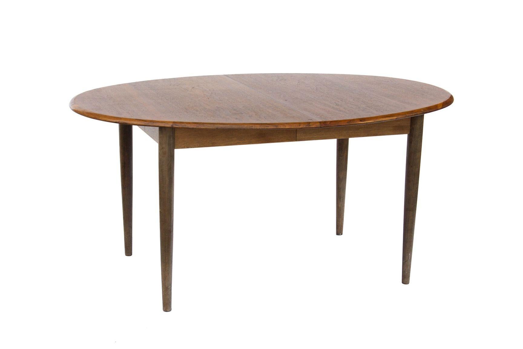 Denmark, 1960s
Danish teak dining table with two leaves by Gudme Mobelfabrik. Made in Denmark. This is a nice shape and size but has some decently heavy wear. The perimeter is in solid teak. 
CONDITION NOTES: General wear to the finish, including