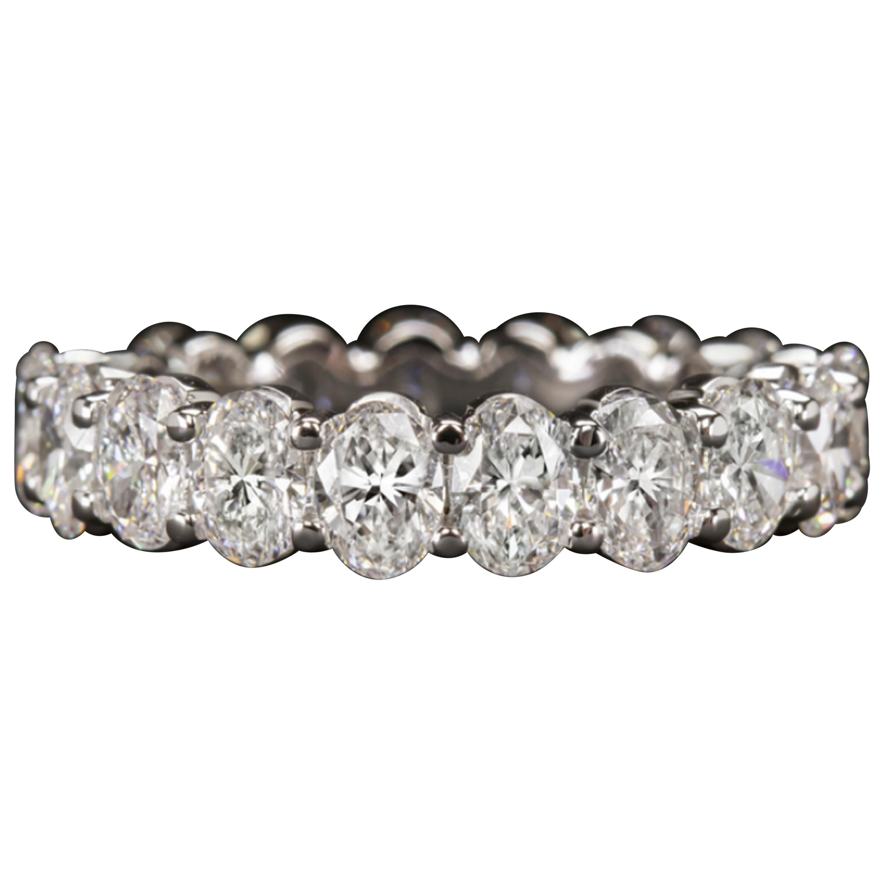 Eternity ring features approximately 3.60 carat of vibrant oval cut diamonds set in an elegantly simple modern band. High quality, perfectly matched, and substantially sized diamonds cover the full diameter of the ring in dazzling sparkle. Bright