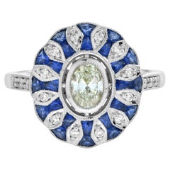 Anello di fidanzamento ovale con diamanti e zaffiri in stile Art Déco e fiori in oro 18 carati