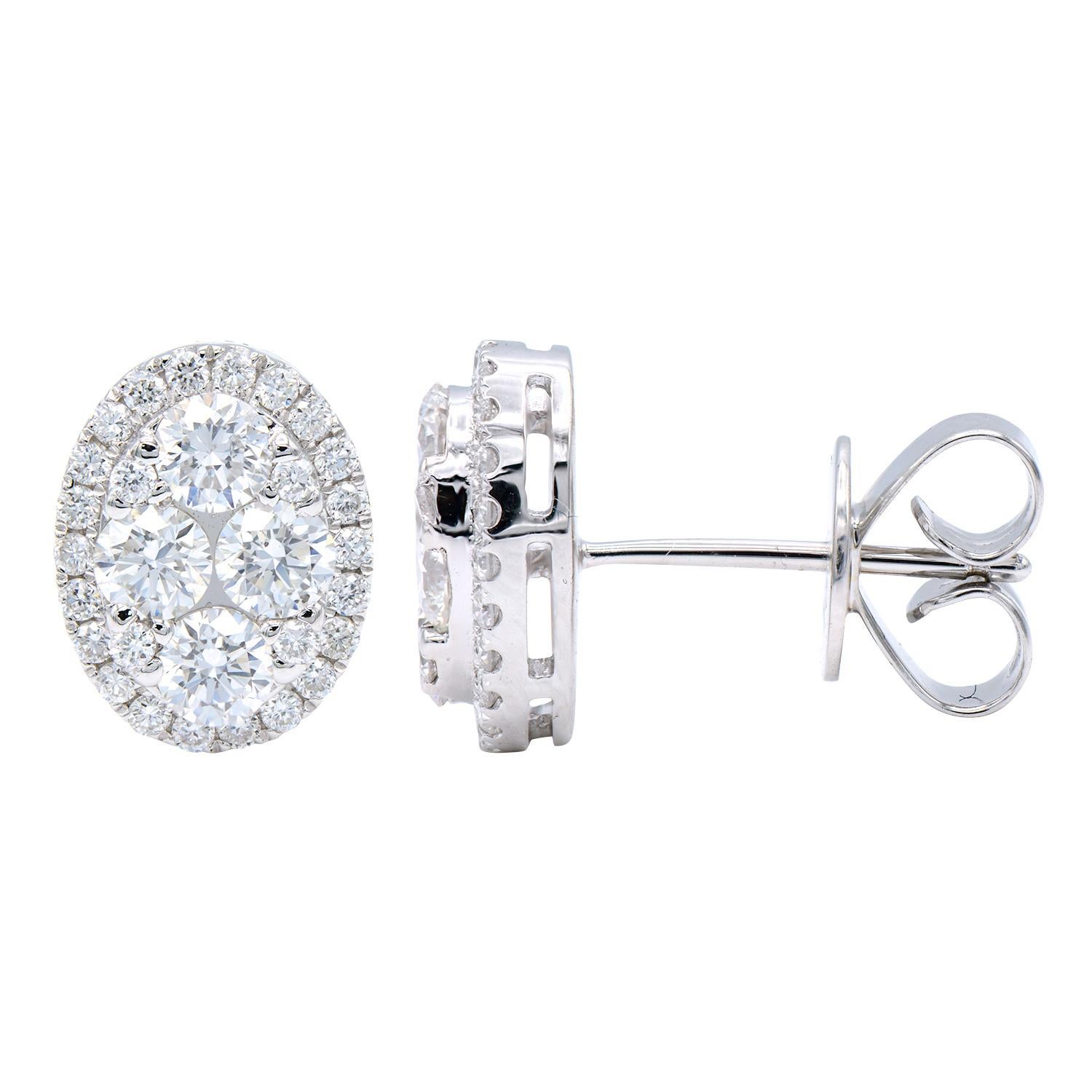 These stunning diamond cluster earrings are oval shaped. The inside is made from 4 larger diamonds and 4 smaller diamonds which are all surrounded by a diamond halo. There is a total of 60 round VS2, G color diamonds totaling 1.09 carats. These