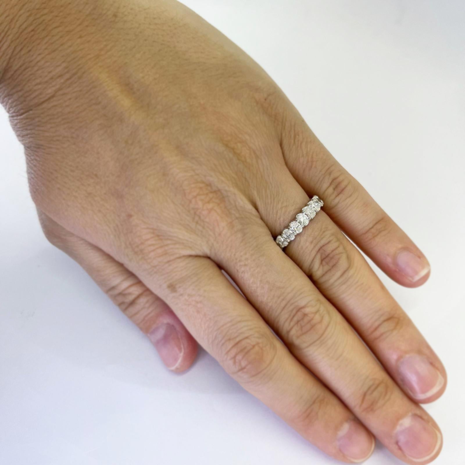 Platinum shared prong eternity band with U gallery featuring 21 oval cut diamonds of VS clarity and G/H color totaling approximately 3.15 carats. Finger size 6. Finished weight is 5.5 grams.