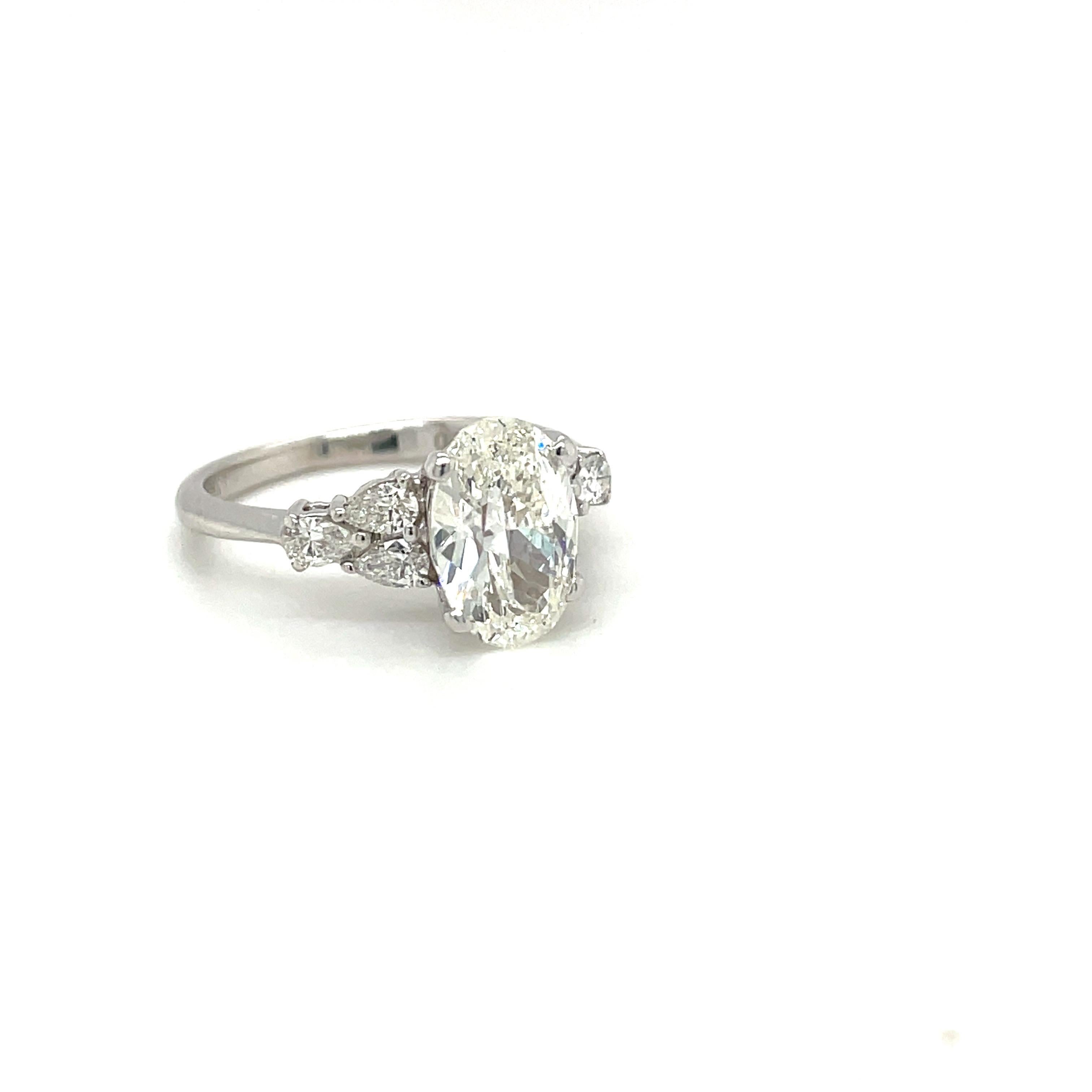 Modern Oval Diamond GIA Certified 1.71 Ct. H VS1 Plat Setting with 0.35ct Pear Diamonds For Sale