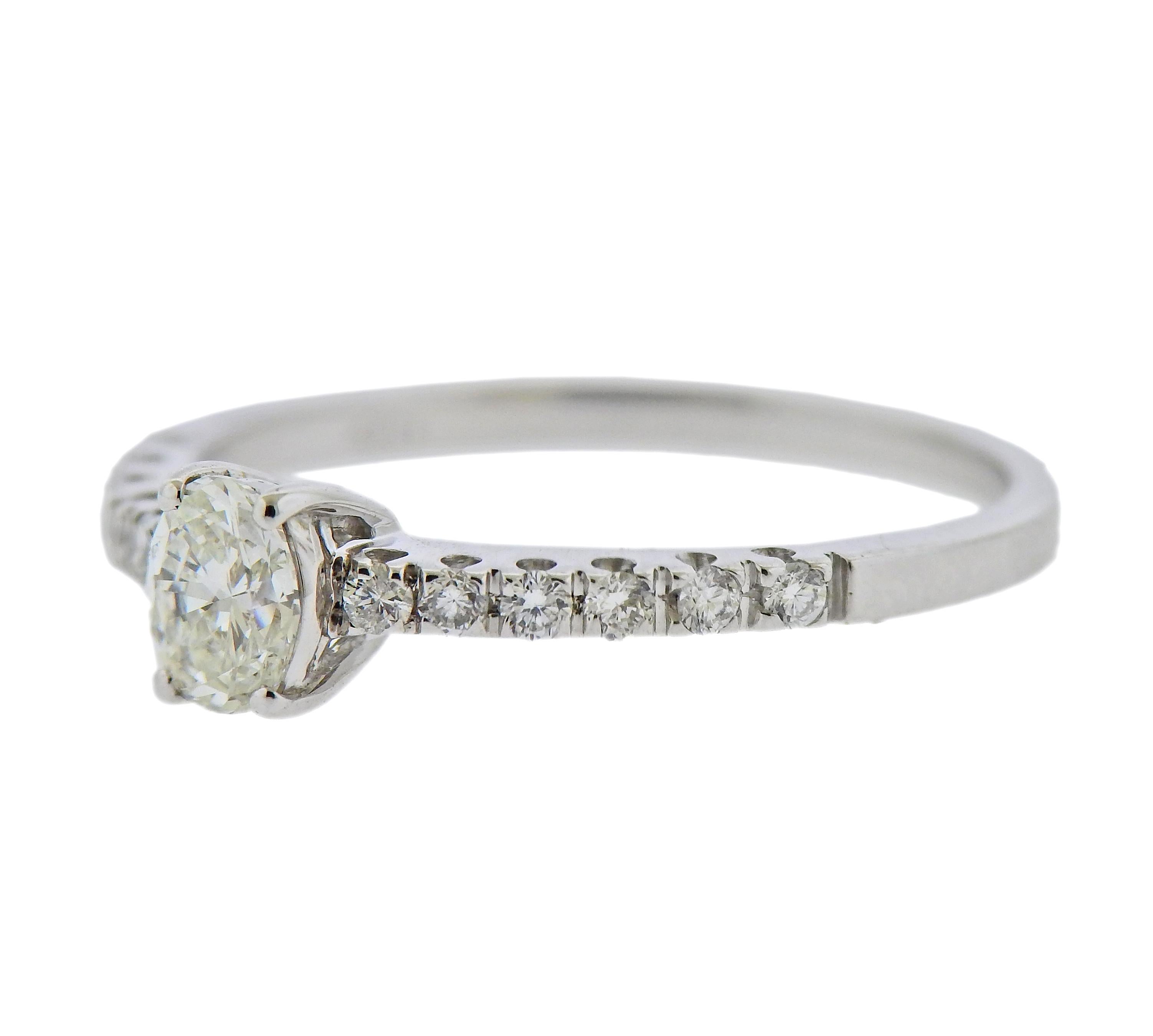 18k white gold engagement ring, with center approx. 0.34ct oval diamond, and size approx. 0.24ctw in diamonds. Ring size - 7. Marked: 750, Italian mark. Weight - 2.4 grams. 