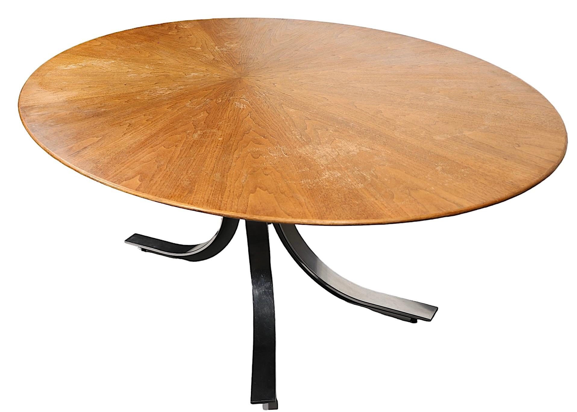 Voguish, sophisticated, and chic conference dining table designed by Osvaldo Borsani, for Stow Davis. The table has a large oval top with a radiating starburst pattern, of  matching walnut veneer panels that expand from the center, and a dramatic