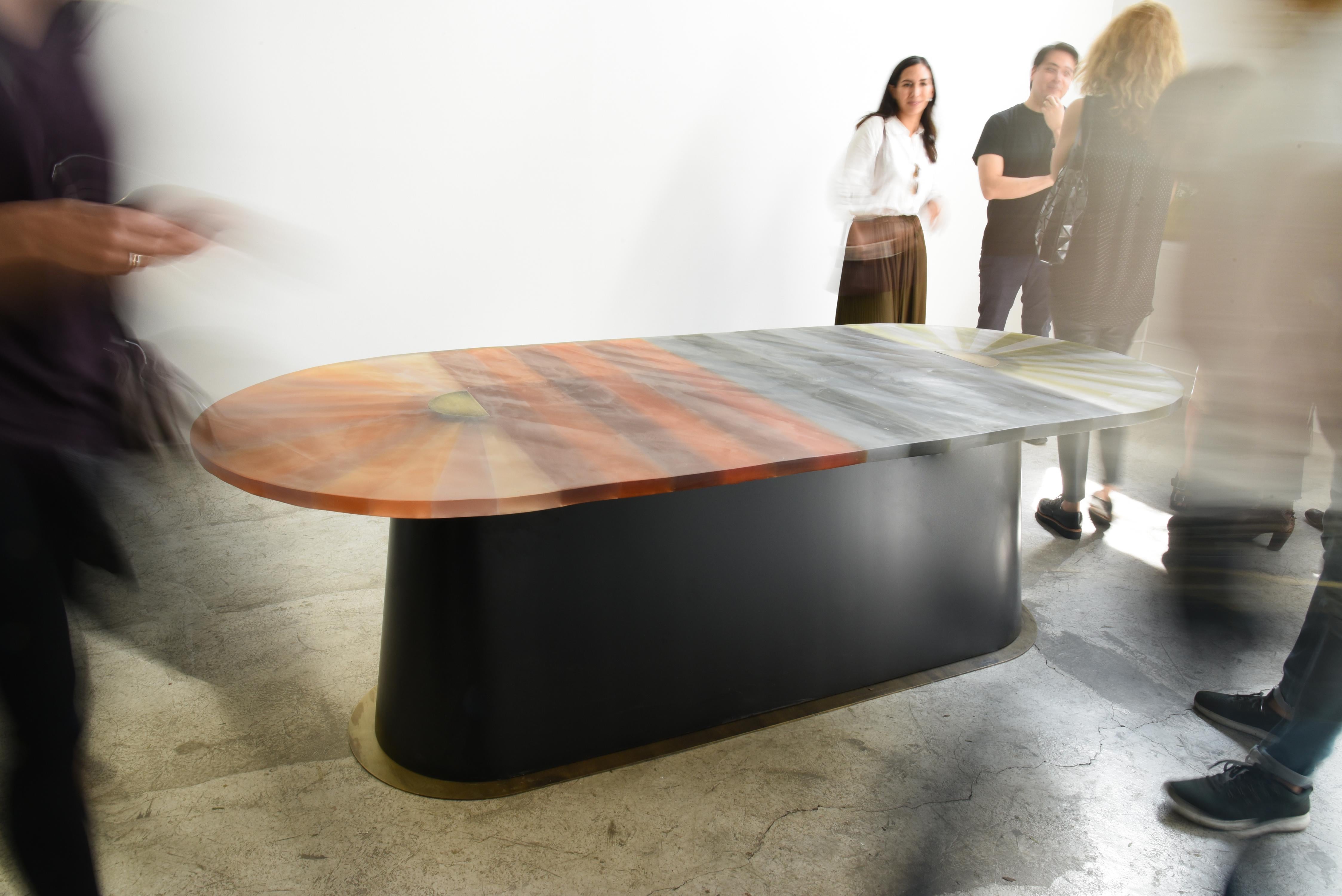 Oval dining table
Resin top
Wood veneer and brushed brass base
This family of furniture pieces is a collaboration between designers Ezequiel Farca + Cristina Grappin and Moises Hernandez. The idea behind this proposal is a chromatic experimentation