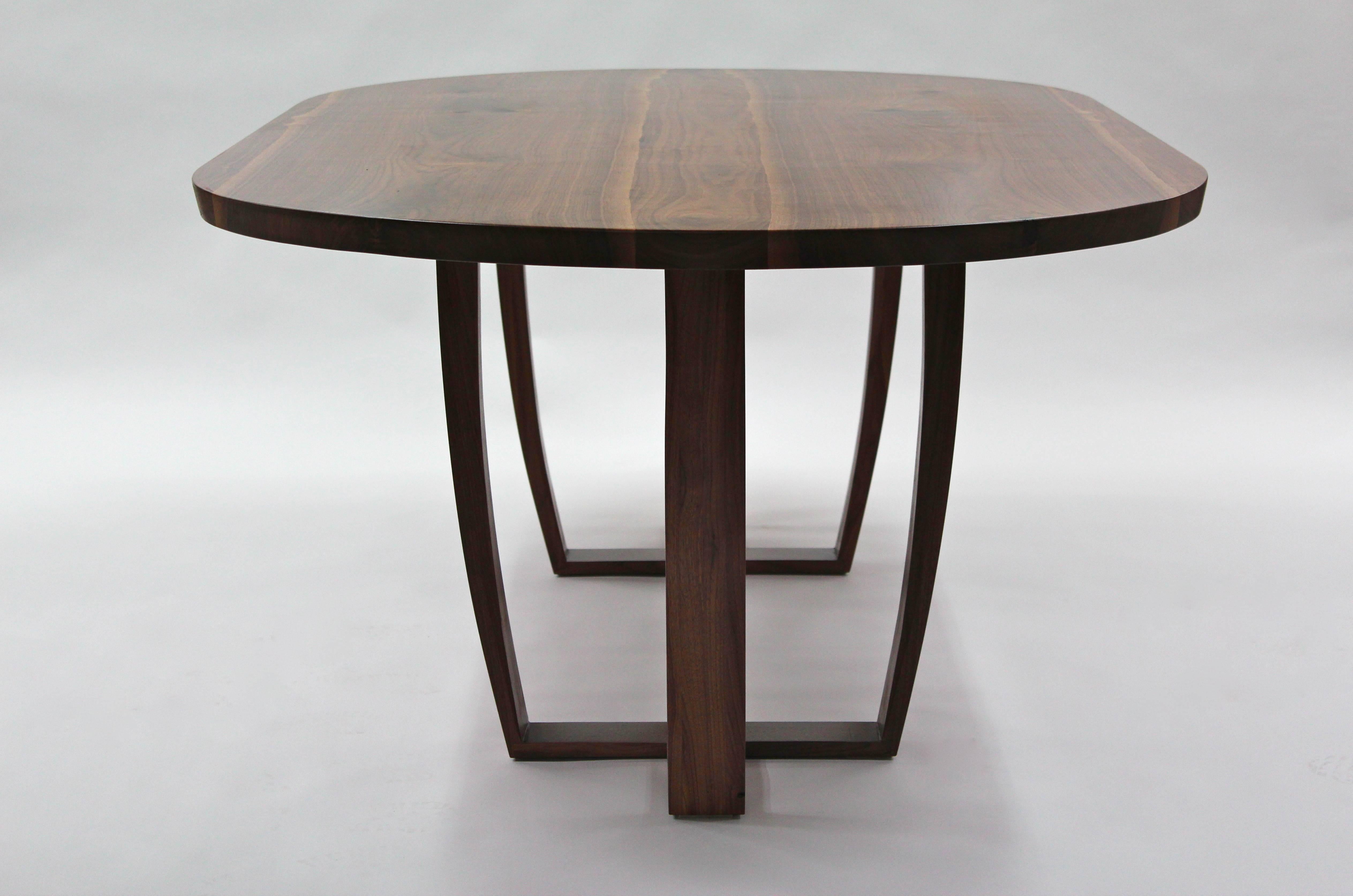 Originally commissioned for a client's contemporary home in Nottingham, England. The top is made from two pieces of inverted, mirror image ( book matched ) 
American black walnut carefully cut into a central slab of walnut, this allows the shape of