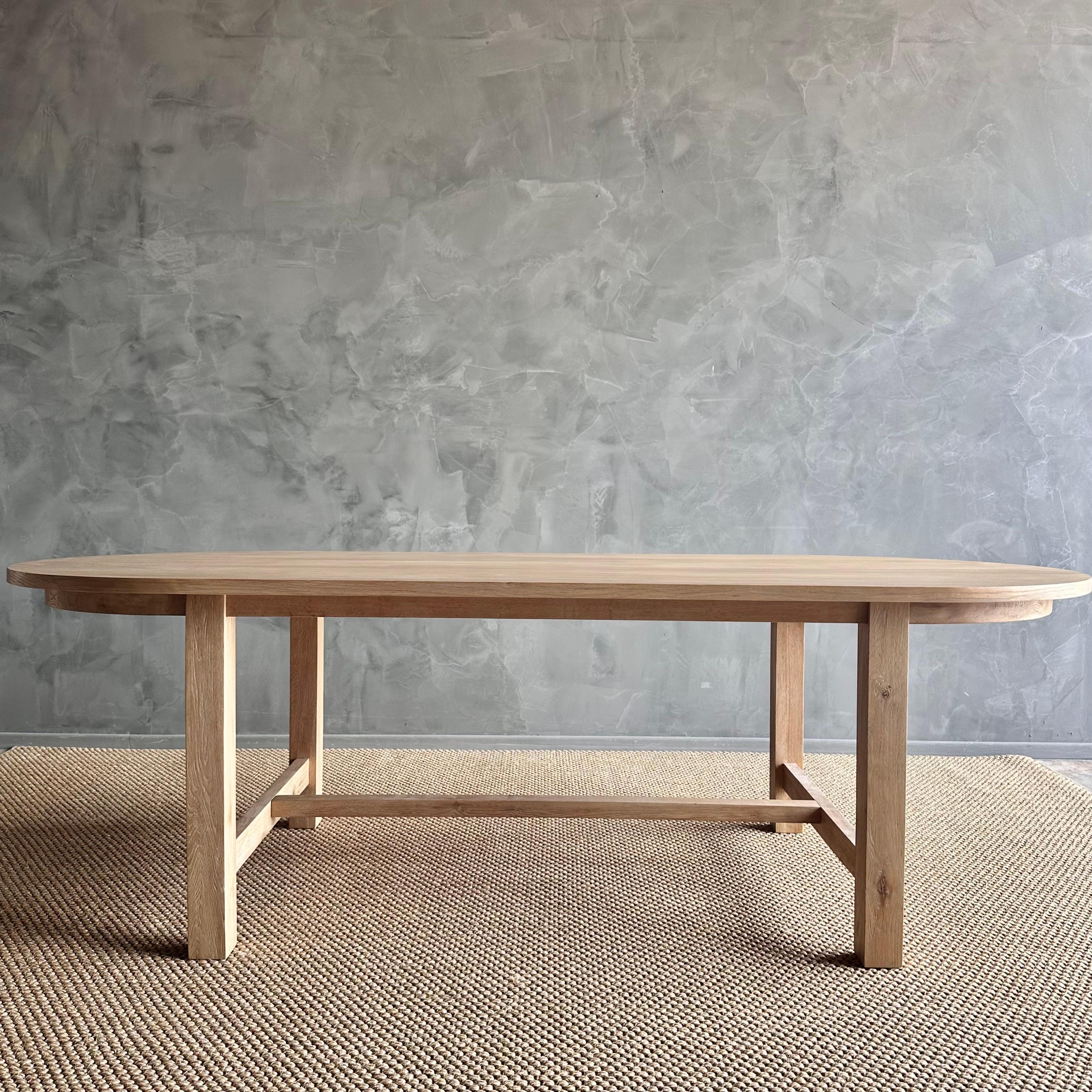 Introducing our exquisite Amber oval dining table, crafted from beautiful white oak for a touch of elegance. Its solid construction ensures durability and longevity, perfect for everyday use. The design is minimal yet with transitional appeal,