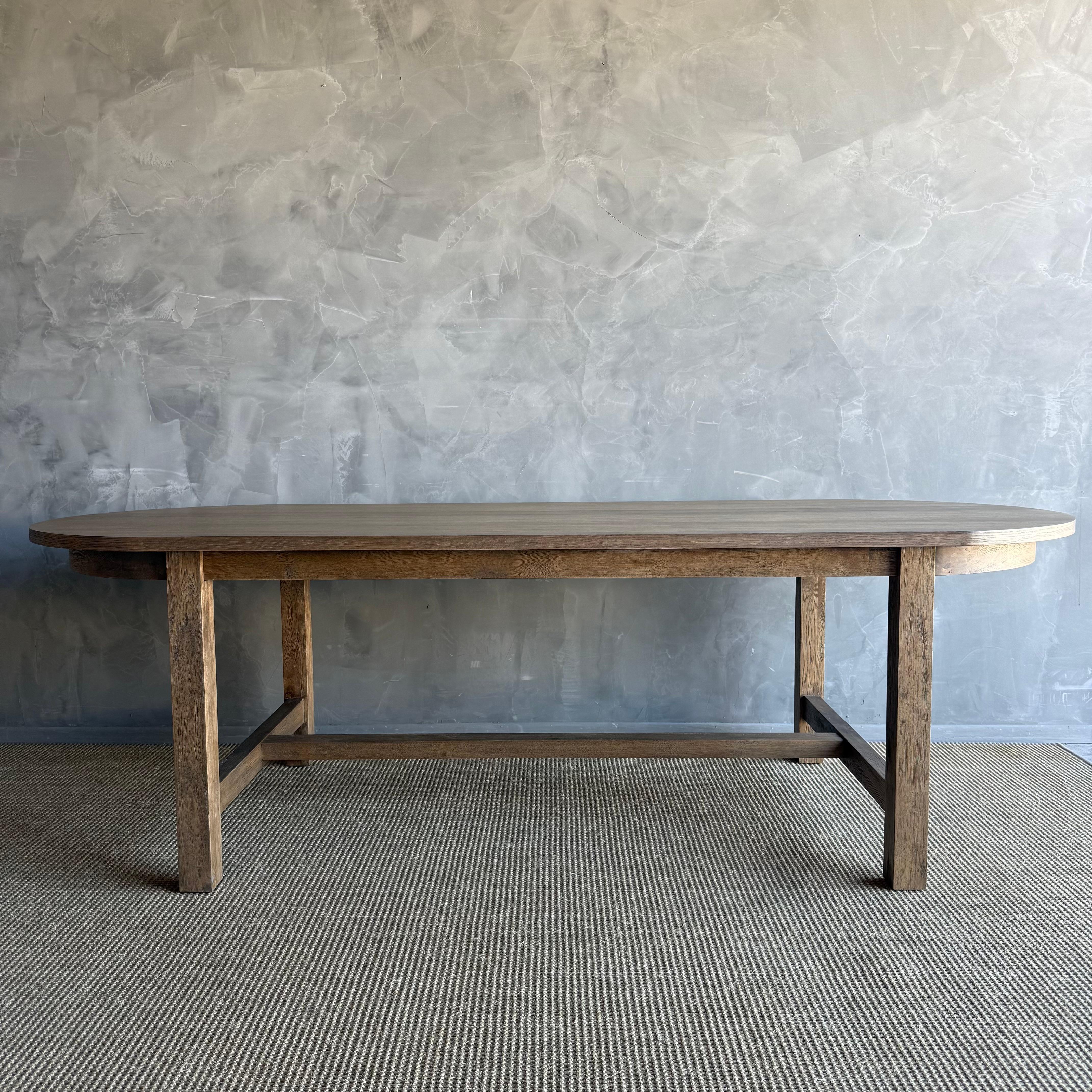Introducing our exquisite Amber oval dining table, crafted from beautiful white oak for a touch of elegance. Its solid construction ensures durability and longevity, perfect for everyday use. The design is minimal yet with transitional appeal,