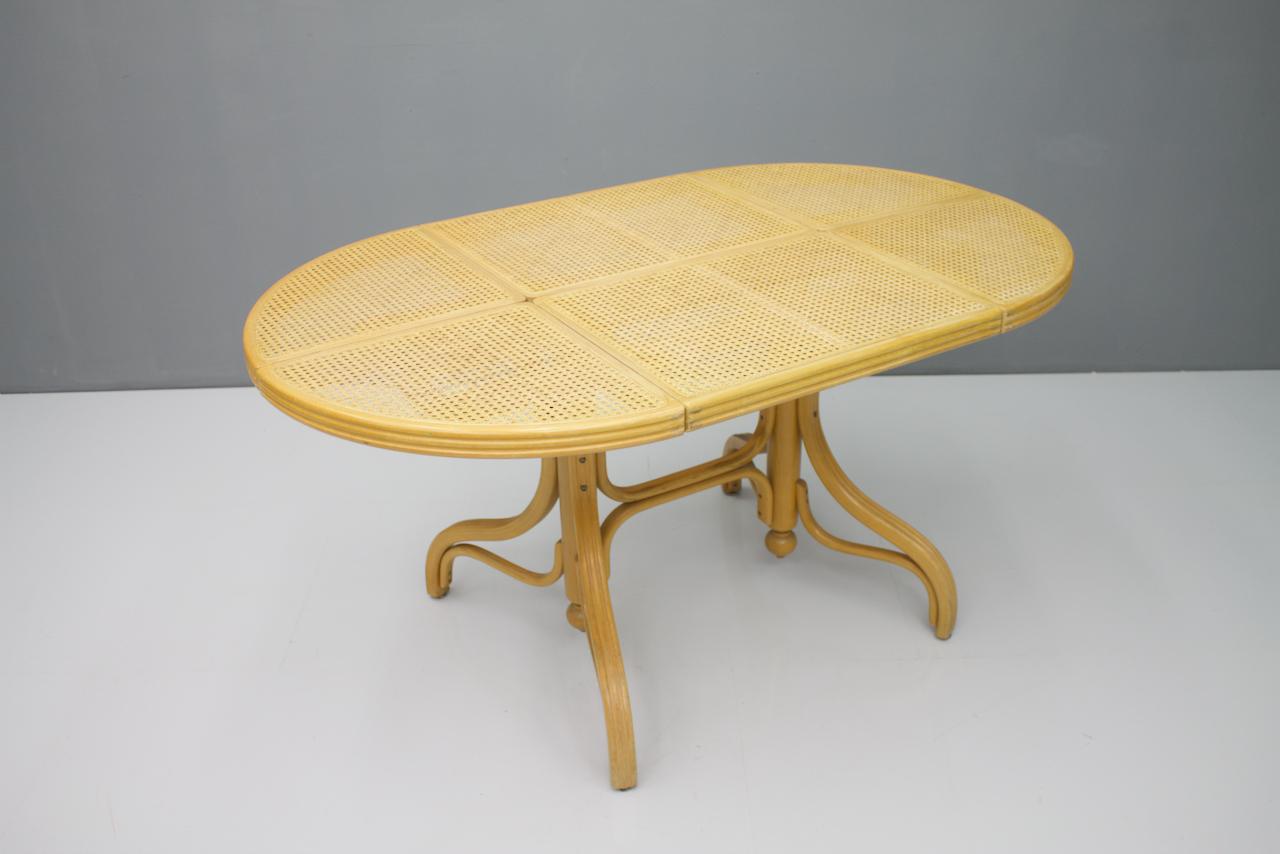 Oval dining table in wood, cane and glass, Germany, 1970s.

Good condition