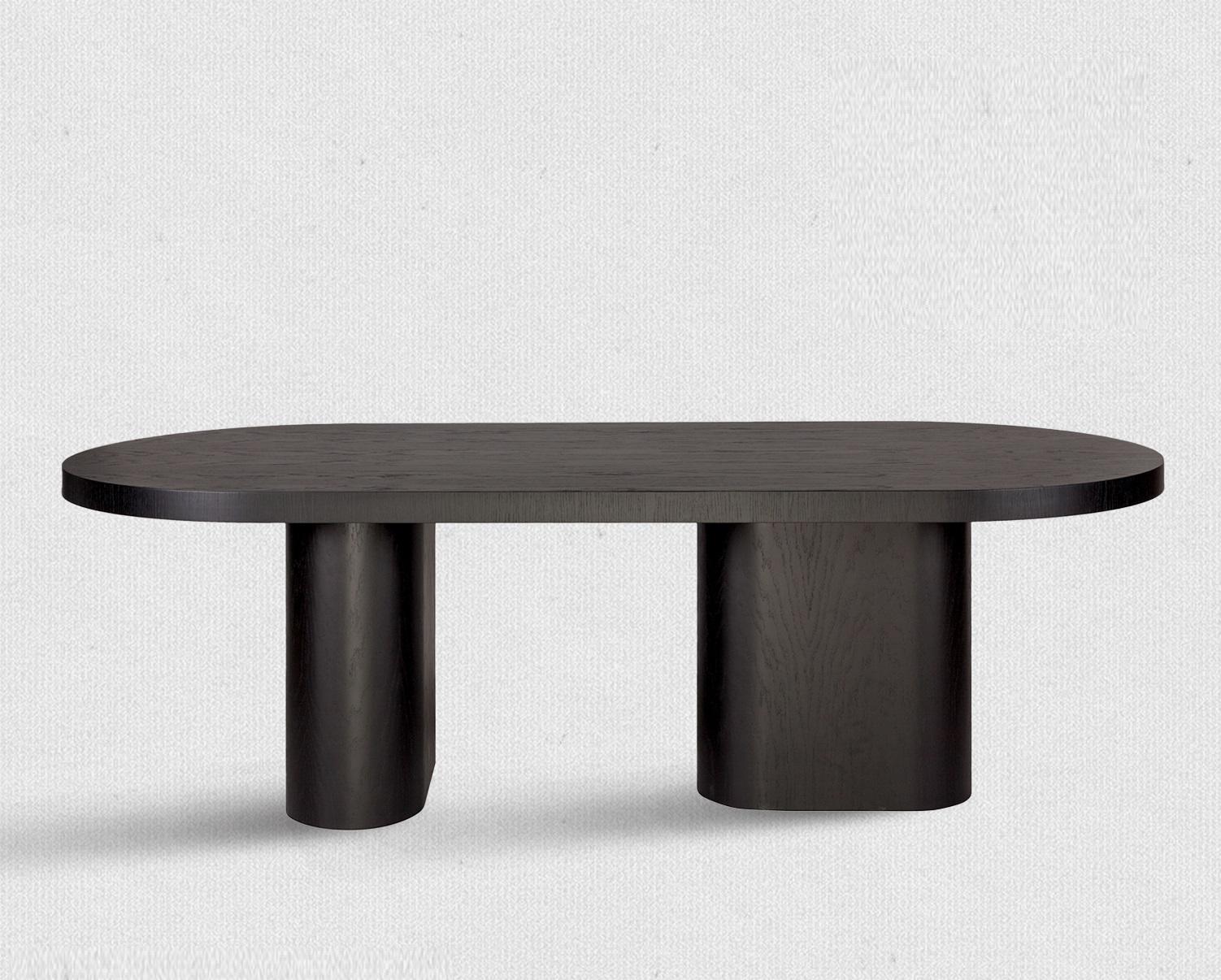Chunky oval dining table featuring a substantial top available in 8 rich Oakwood finishes. The dining table has two identical curved plywood bases, and a chunky top with 6cm thickness. There is the possibility of lacquering the top and base upon
