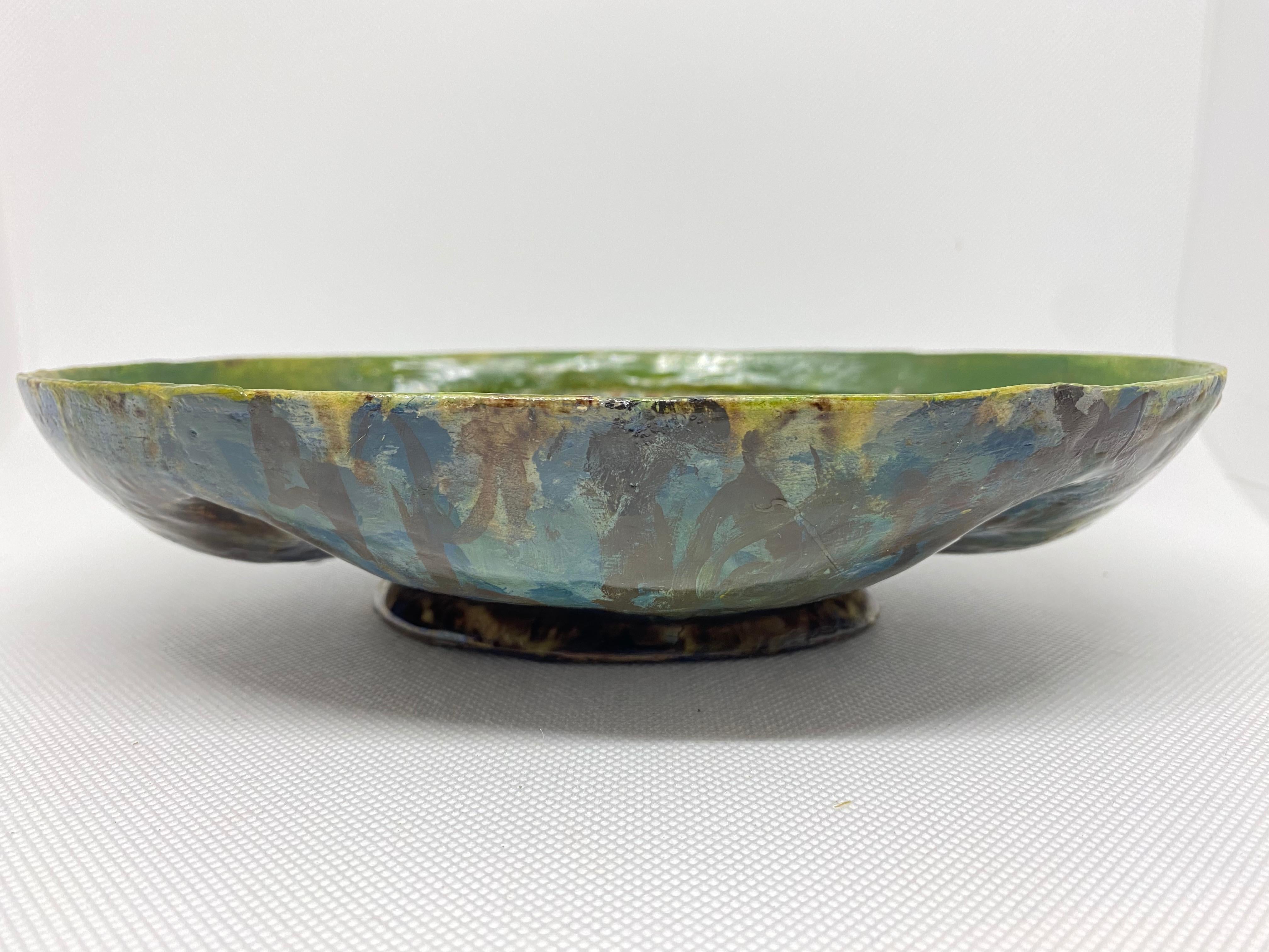 French glazed earthenware bowl in the manner of Bernard Palissy.

Bernard Palissy (1510-1590) was a French potter who created extravagant glazes on his rustic ceramics which often featured naturalistic forms and creatures. He prepared a plan for a