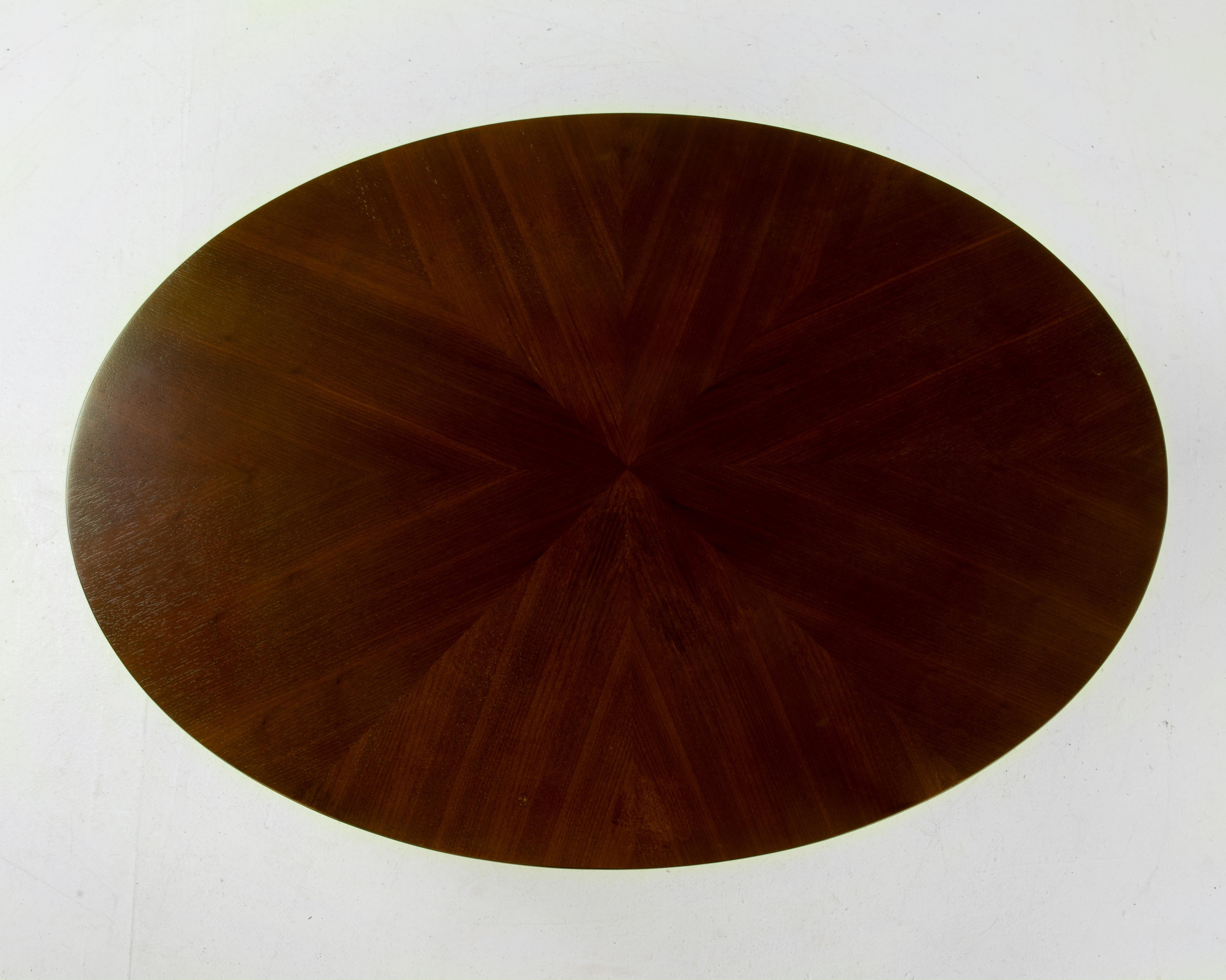 An oval drum or barrel coffee table with wonderful wood grain. Floating on a recessed black base with tapered sides, a very well executed piece.