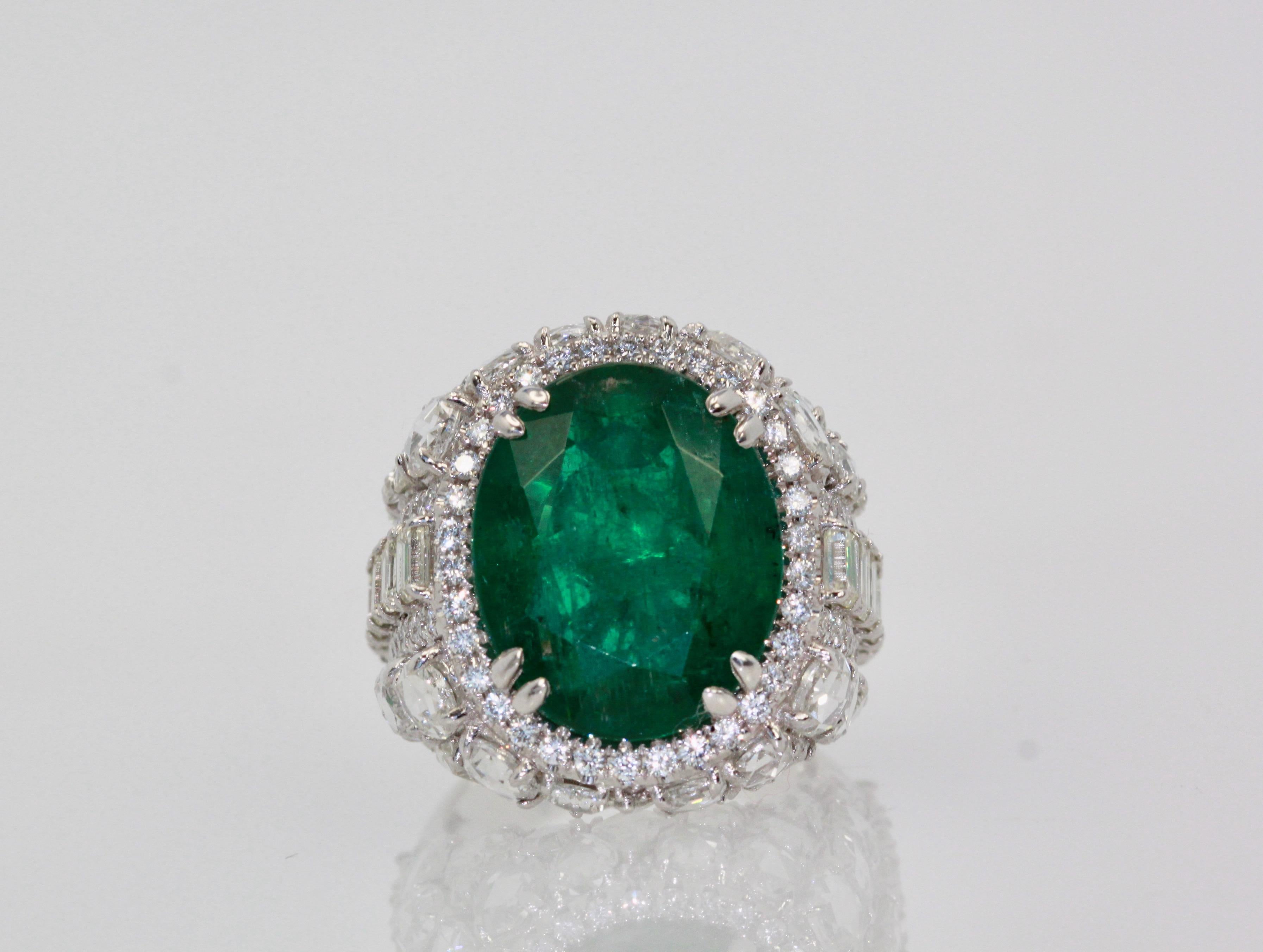 This oval Emerald weights in at 12.25 carats and is a gorgeous Emerald Green with transparency.  The Diamonds weigh in at 8.85 Carats and the mount is exceptional the Diamonds are VS1-VS2 and G-J in color.  This is a bombe mount.  The shoulders of