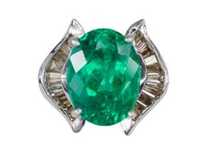 Oval Emerald and Baguette Diamond Horseshoe Bypass Ring