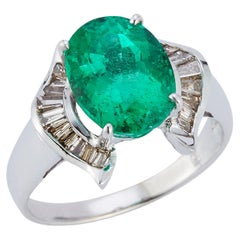 Oval Emerald and Baguette Diamond Horseshoe Bypass Ring