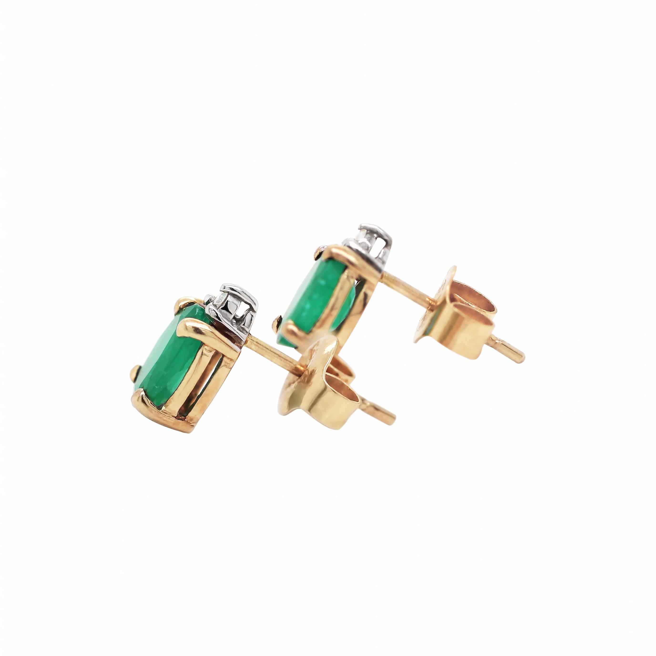 These stud earrings feature an oval cut emerald weighing approximately 0.60ct in each, mounted in an 18 carat yellow gold four claw, open back setting. The emerald is beautifully accompanied by a round brilliant cut diamond above, weighing