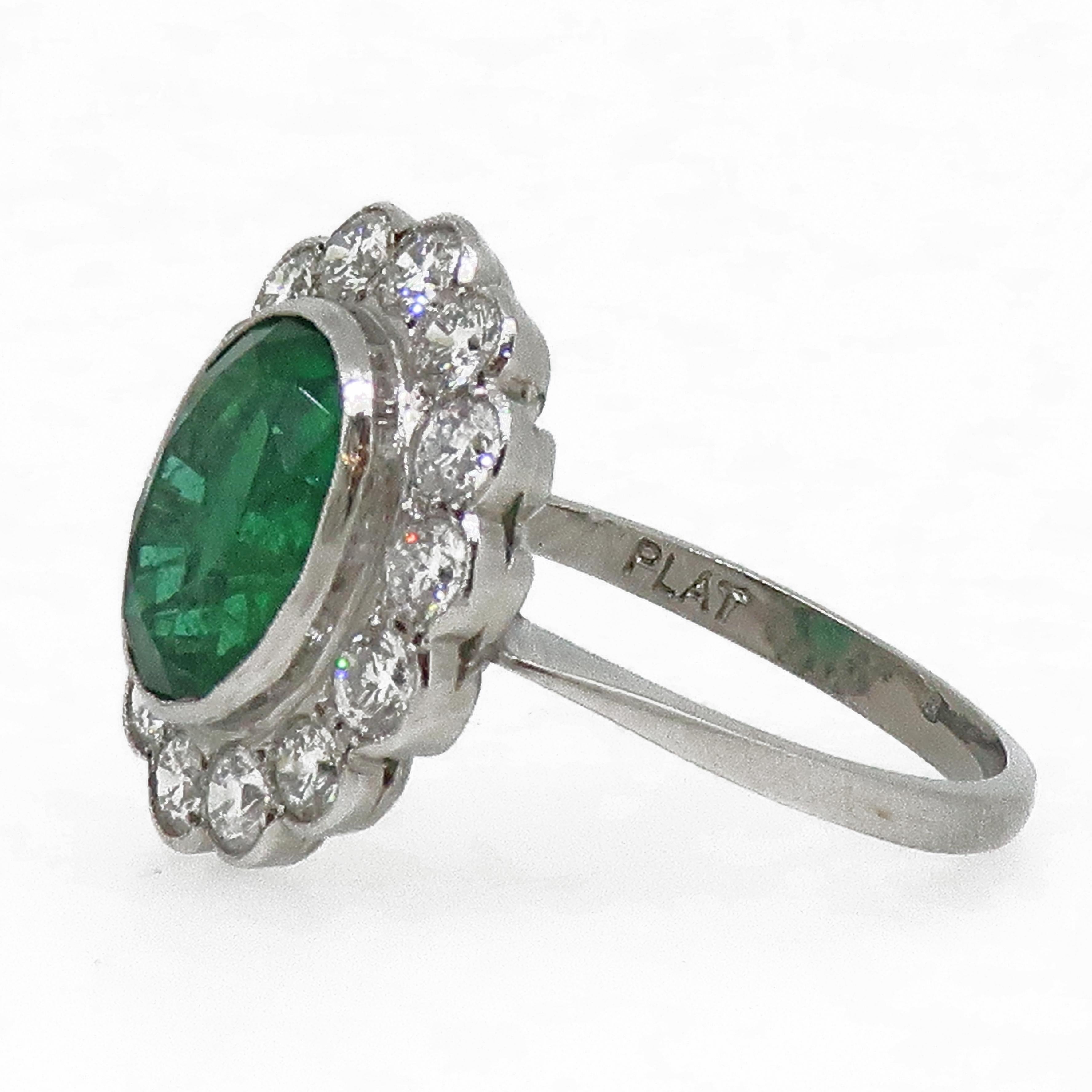 Platinum Oval Emerald and Diamond Cluster Ring

Large traditional oval emerald and diamond cluster ring. This stunning ring has a lovely vibrant green emerald surrounded by a halo of fourteen white brilliant cut diamonds. All stones set in a set in