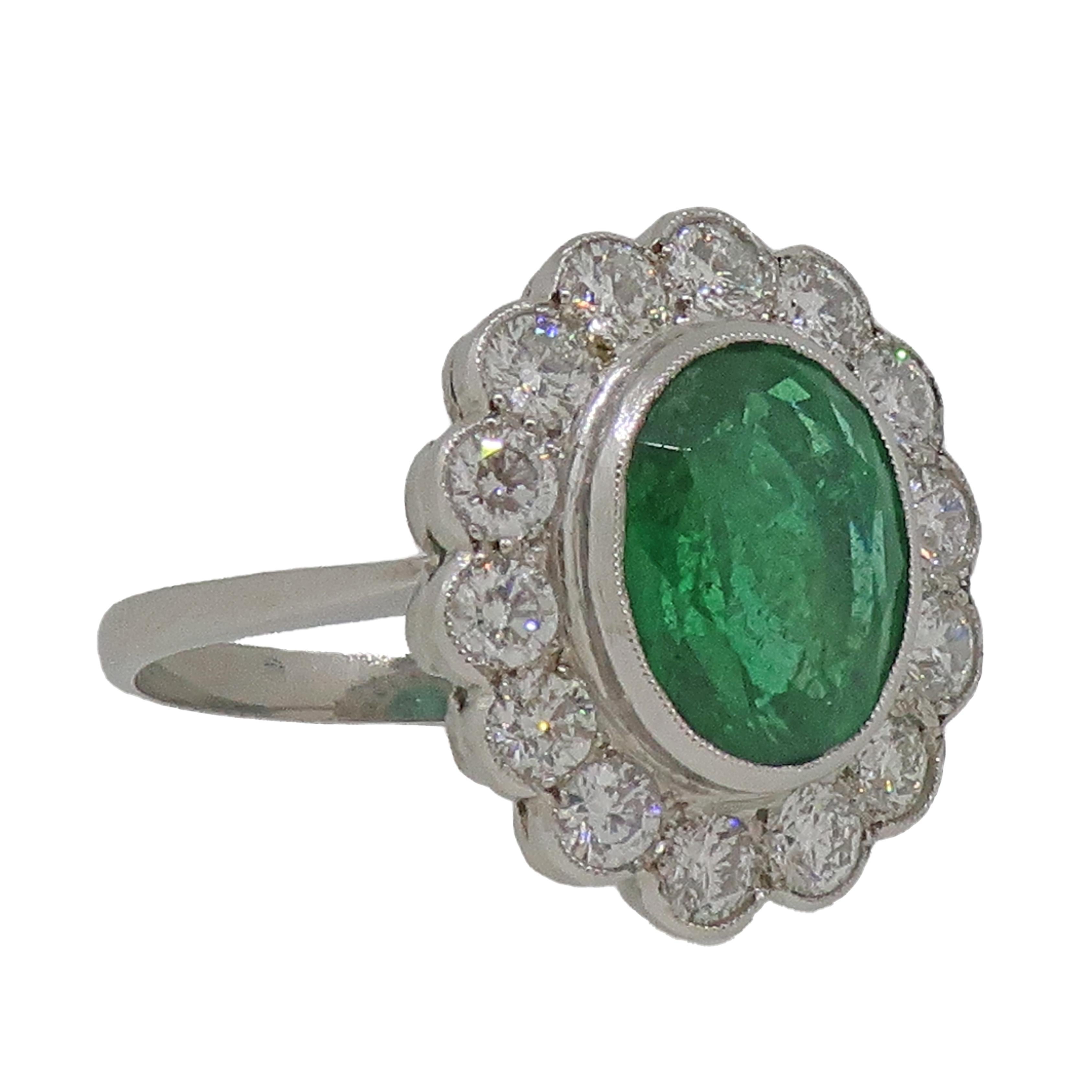 Oval Emerald and Diamond Cluster Ring Platinum In Good Condition In East Grinstead, GB