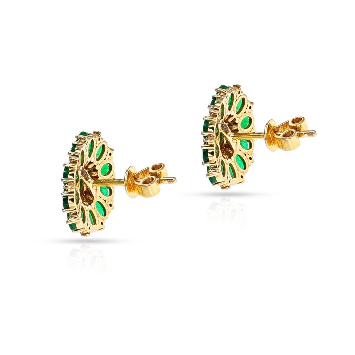 A pair of Oval Emeralds and Diamonds Floral Stud Earrings set in18k Yellow Gold. The emeralds weigh 2.95 carats and the diamonds weigh 0.30 carats. The total weight of the earring is 4.68 grams. The dimensions are 0.59