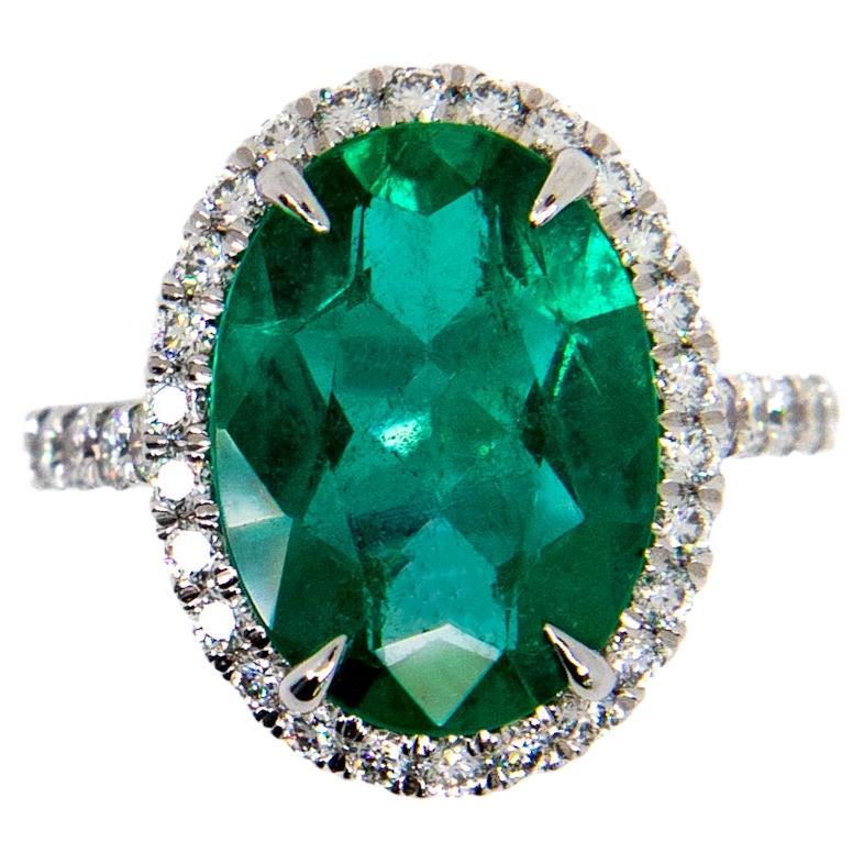 Oval Emerald and Diamond Halo Ring