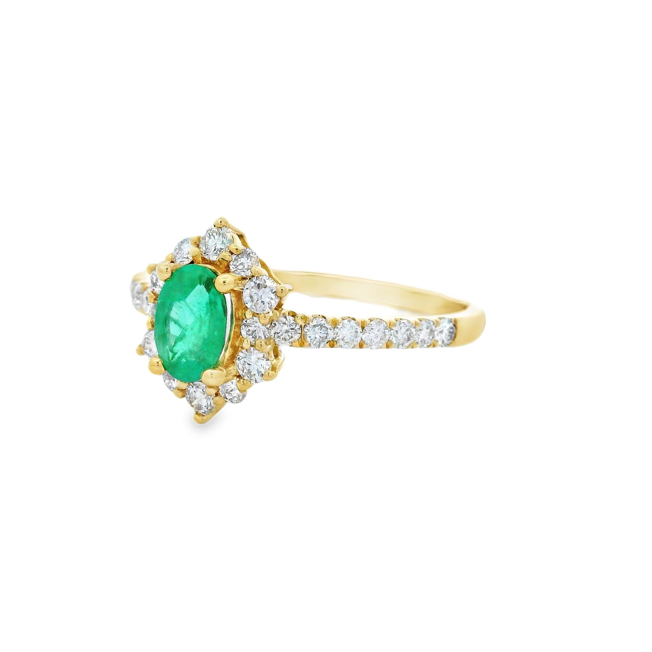 This elegant ring features a vivid 6x4mm oval-cut emerald weighing 0.45 carats, framed in a sparkling diamond halo. Crafted in rich 14K yellow gold, the ring showcases 26 round brilliant-cut diamonds totaling 0.43 carats, adding brilliance to the