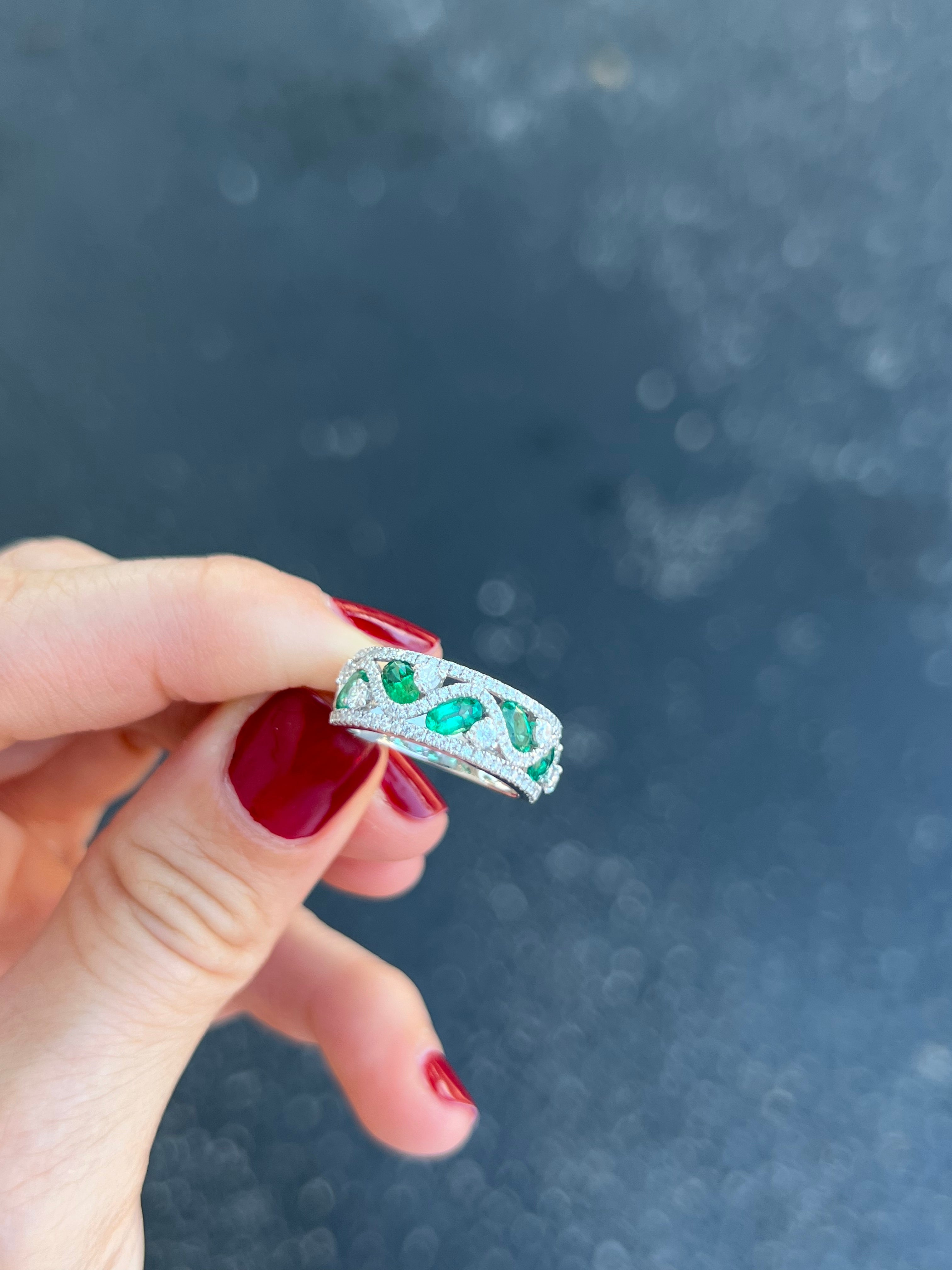 18K white gold, oval emerald and diamond band. 

Features
18K white gold
1.10 carat total weight emerald
.79 carat total weight diamonds
Ring size 6, can be sized up.
Can be sized down 1 size maximum.