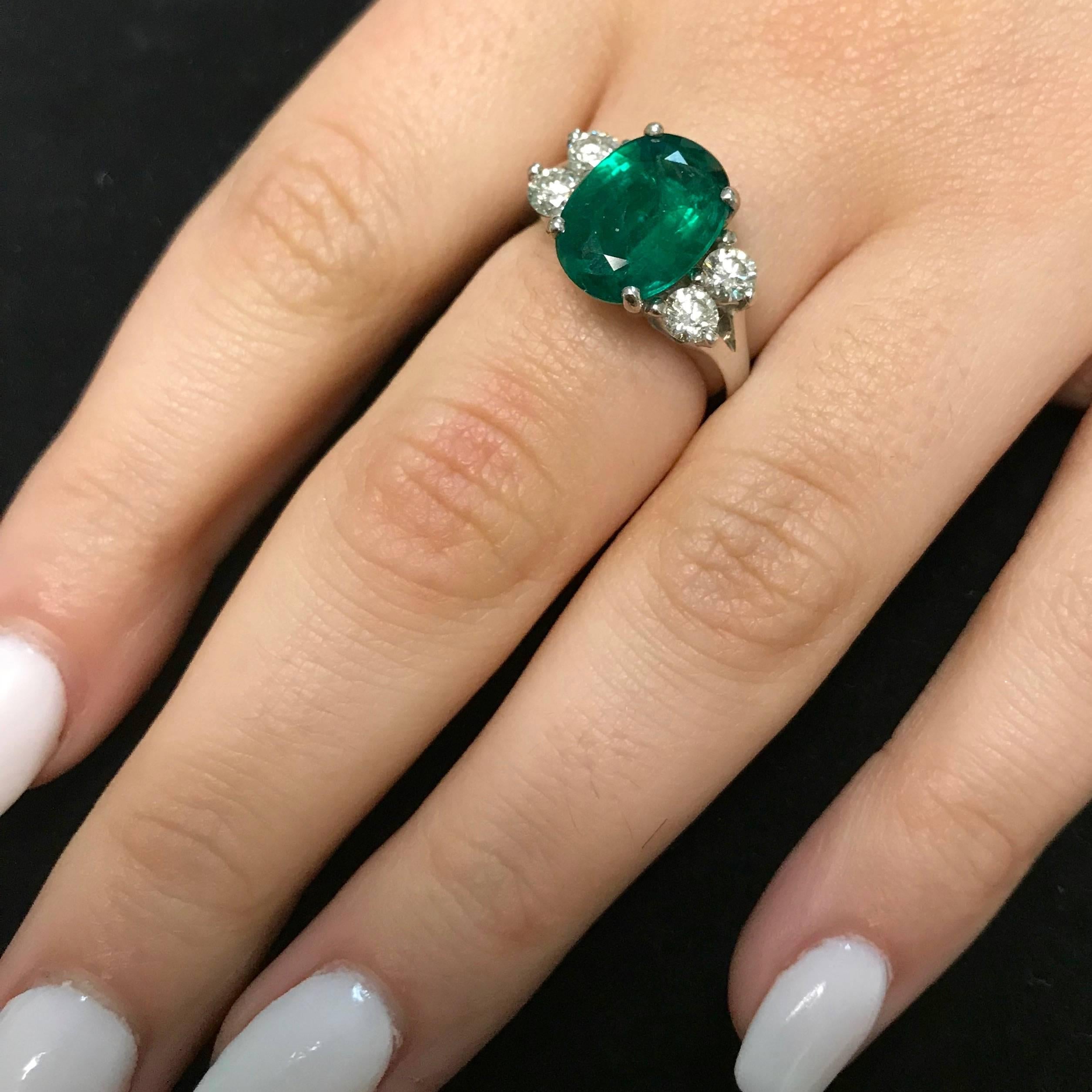 Material: 18k White Gold
Gemstones: 1 Oval Emerald at 3.77 Carats. Measuring 9 x 12.5 mm.
Diamonds: 4 Brilliant Round White Diamonds at 0.72 Carats. SI Clarity / H-I Color. 
Ring Size: 6.5. Alberto offers complimentary sizing on all rings.

Fine