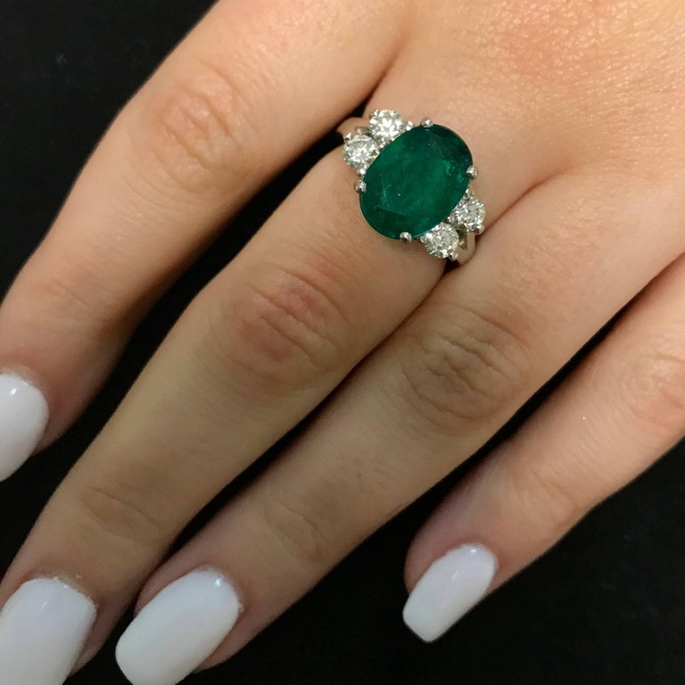 Oval Emerald and Diamond Side Stone Engagement Ring For Sale at 1stdibs
