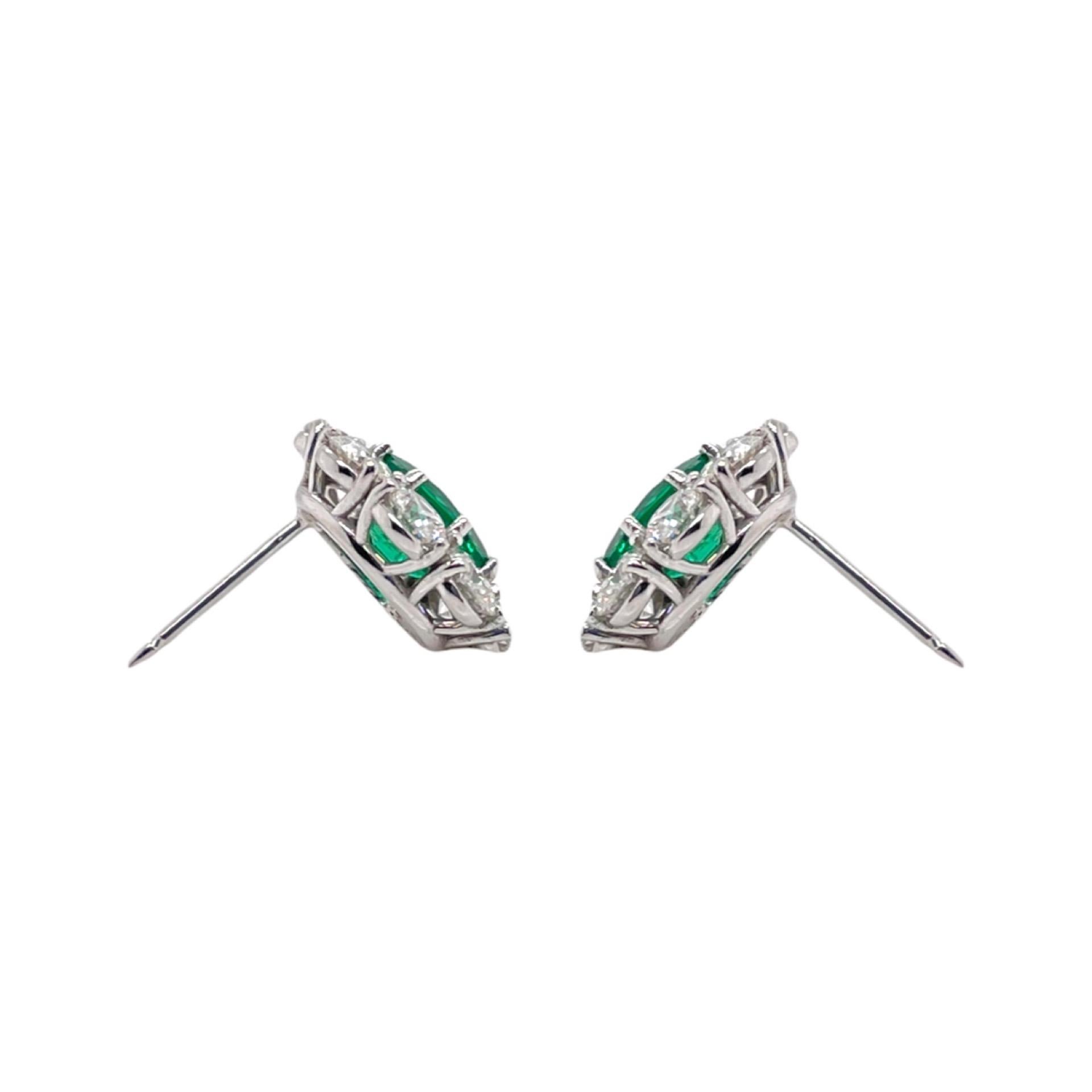 Earrings contain 2 fine oval emeralds, 2.38tcw and 16 round brilliant diamonds surrounding center stones, 3.12tcw. Diamonds are colorless and VS in clarity, excellent cut. All stones are mounted in a handmade 18k prong setting. Earrings have a push