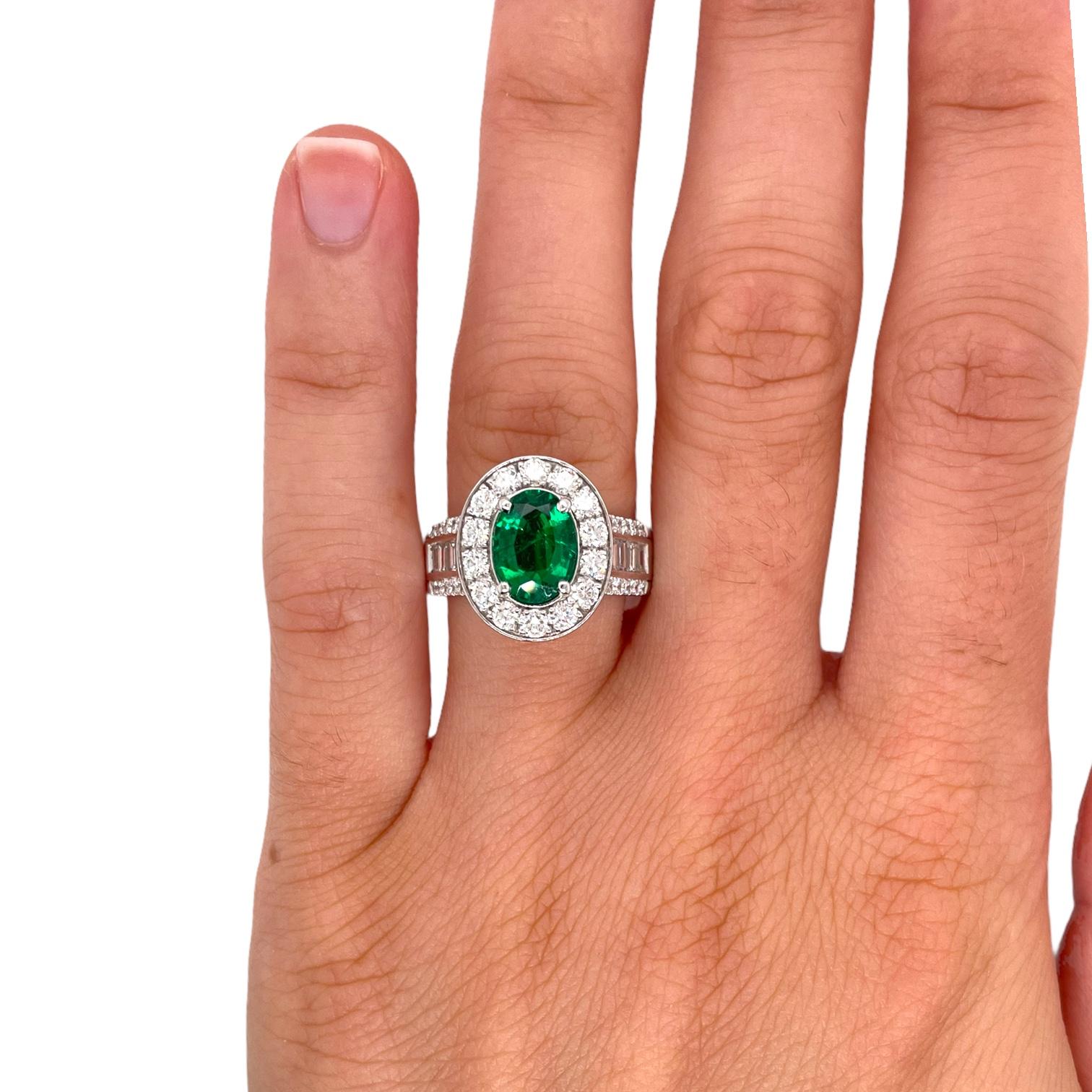 Fine oval emerald and diamond ring in 18k white gold. Ring contains 1 center 9x6mm oval shape emerald 1.40ct, round brilliant diamonds 1.12tcw and baguette diamonds 0.70tcw. Top of ring measures approximately 15x12mm and band measures 6.8mm tapering