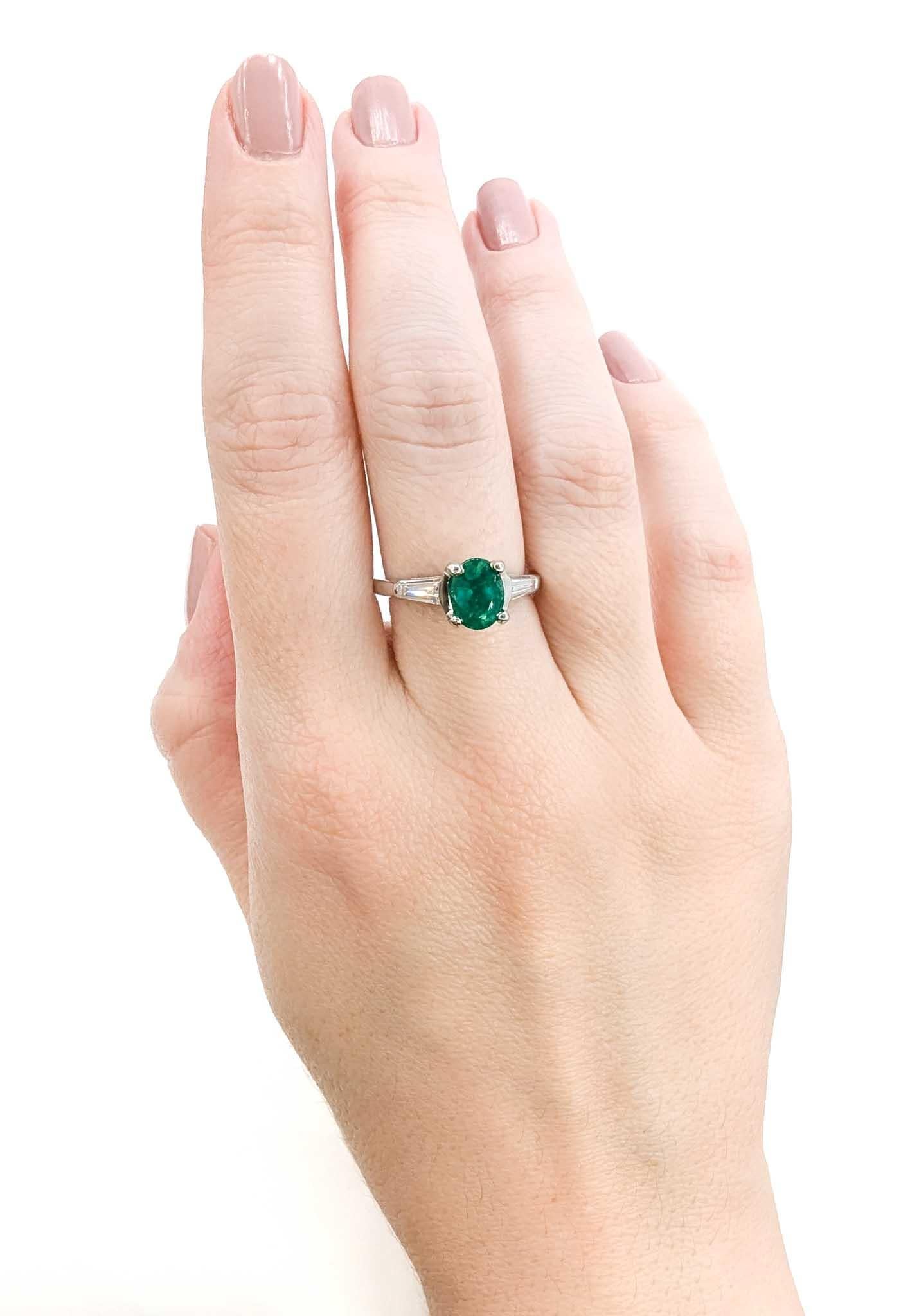Vibrant Oval Emerald & Diamond Ring in Platinum

Introducing this vintage exquisite Emerald ring, meticulously crafted in 900pt platinum. The centerpiece showcases a vibrant oval cut 1.19ct emerald, renowned for its rich green hue and symbolizing