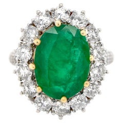 Oval Emerald Ring With Diamond Halo Setting 6.24 Carats 18K Gold