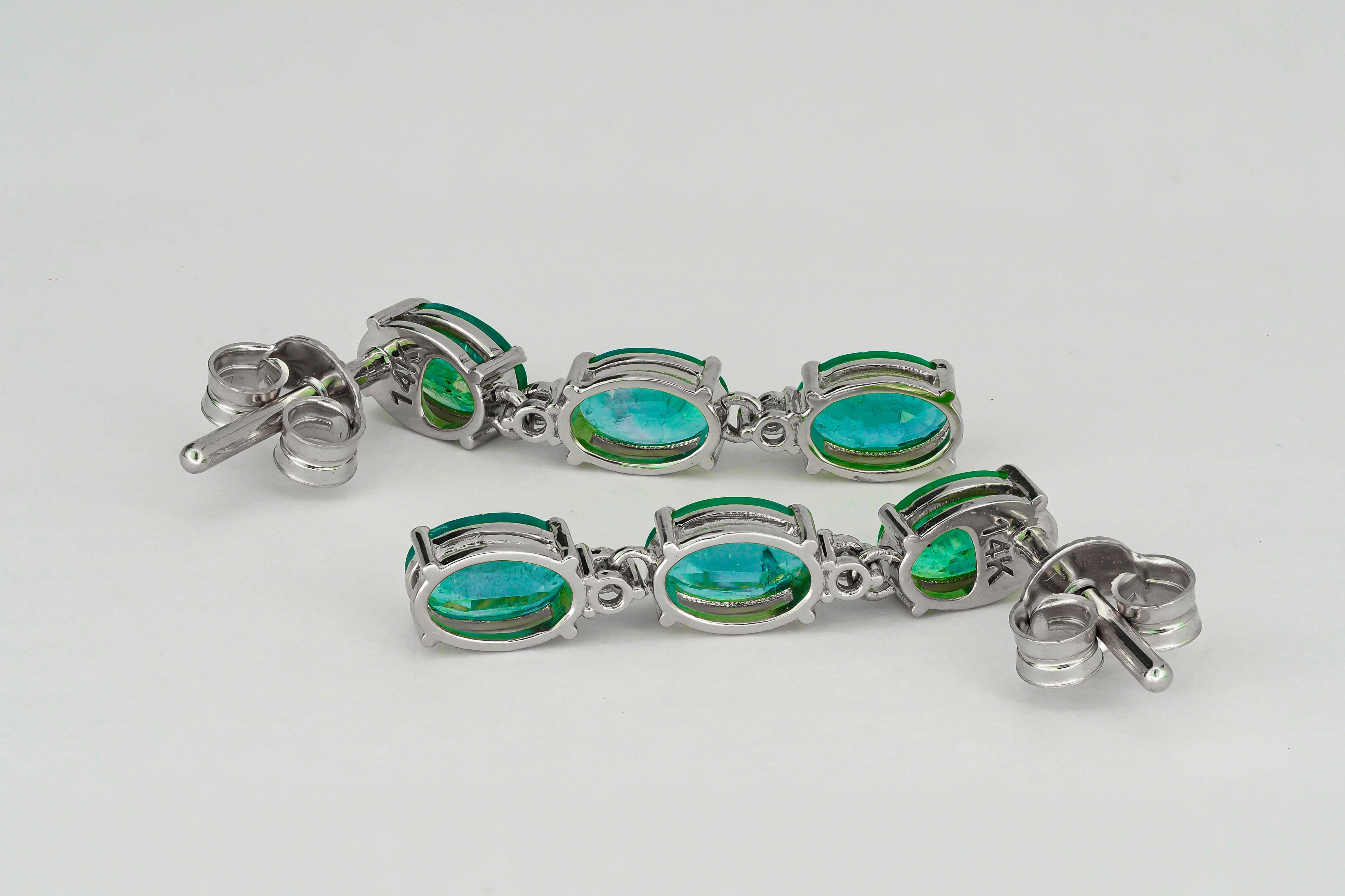Women's Oval emeralds 14k gold earrings studs.  For Sale